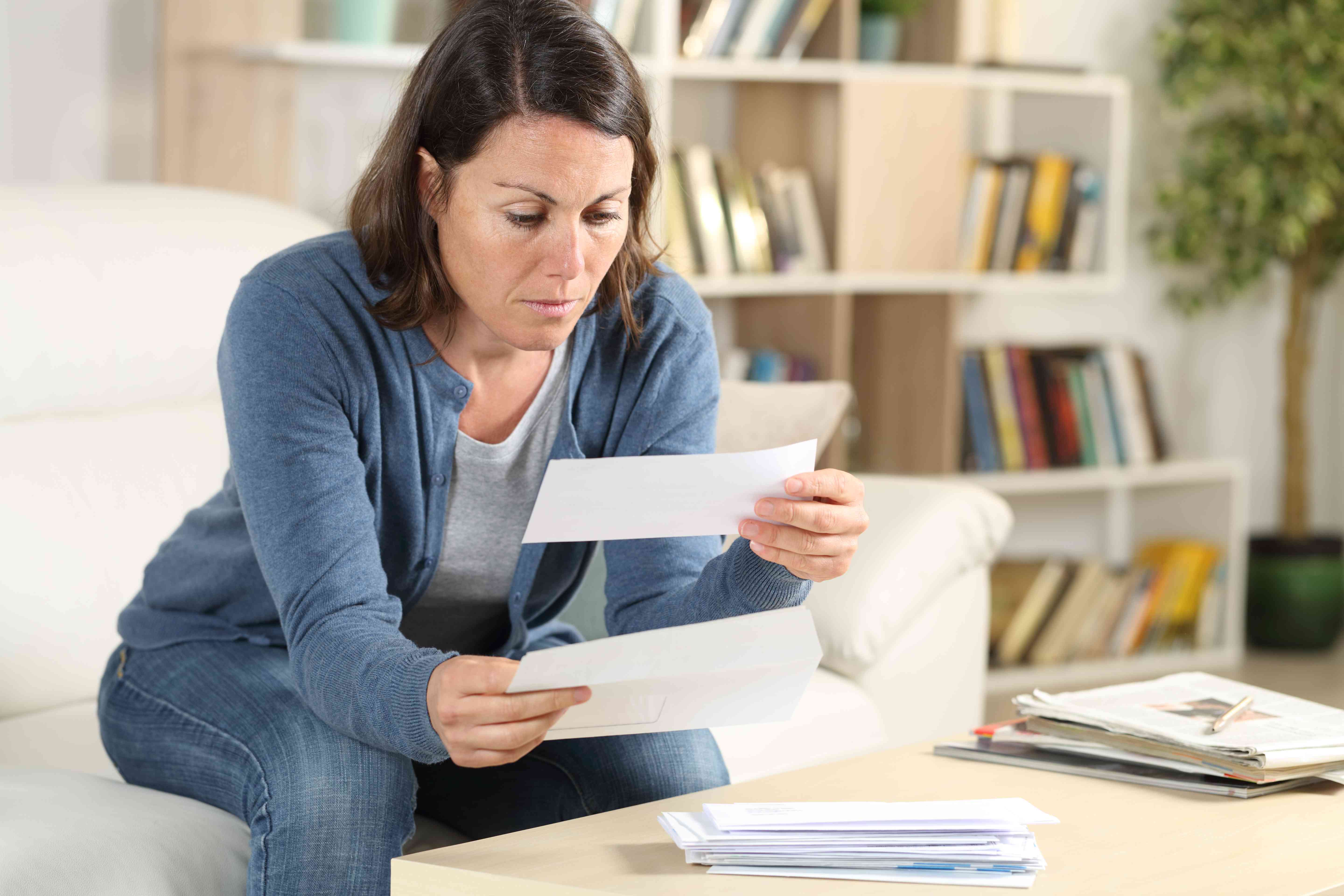 Worried woman looking at overdraft fee from bad checks