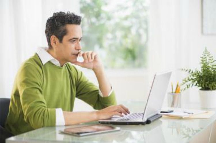 Man at computer looking thoughtful