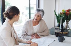 Older woman discusses a prepaid tuition plan with her daughter