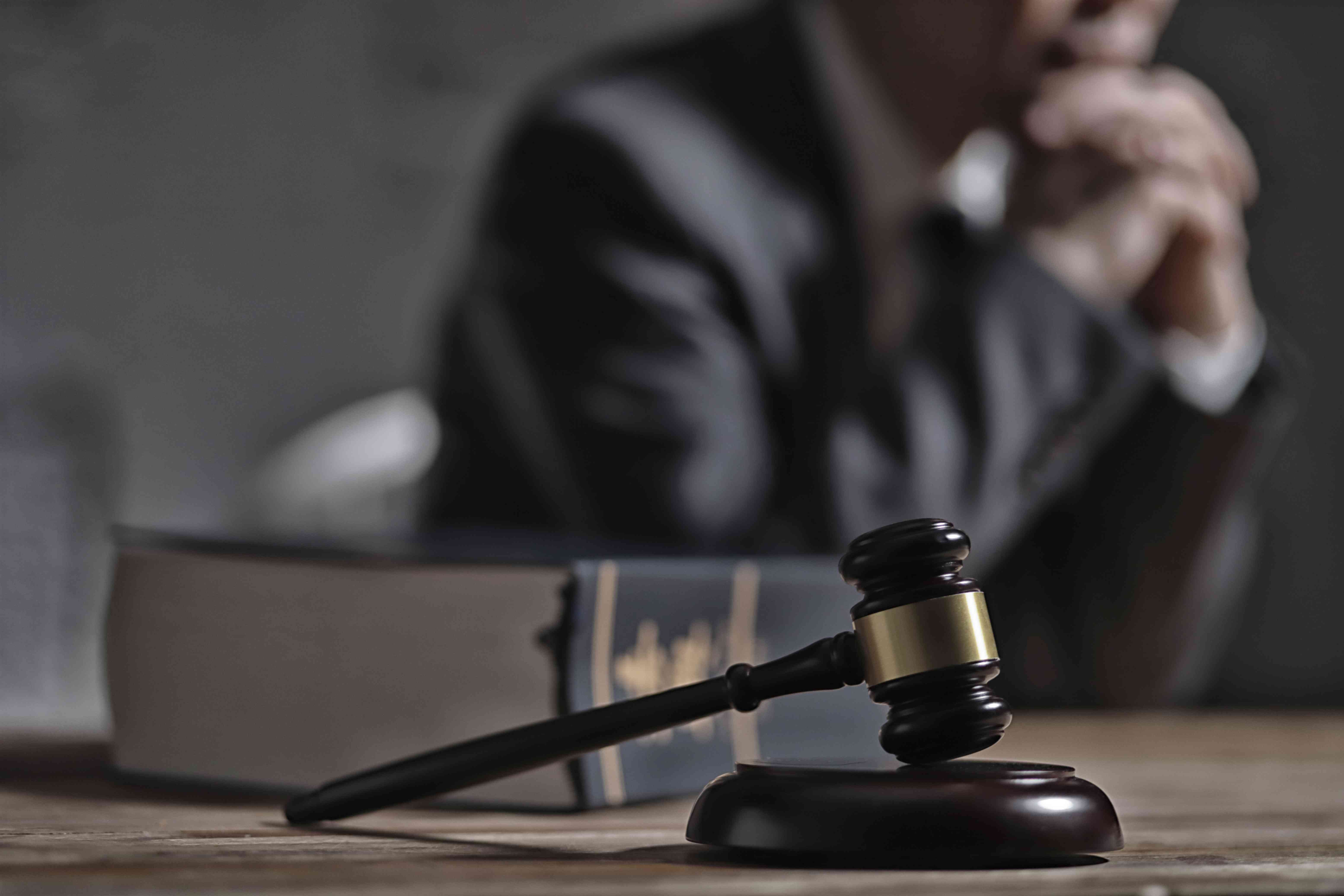 Gavel and law book in front of lawyer