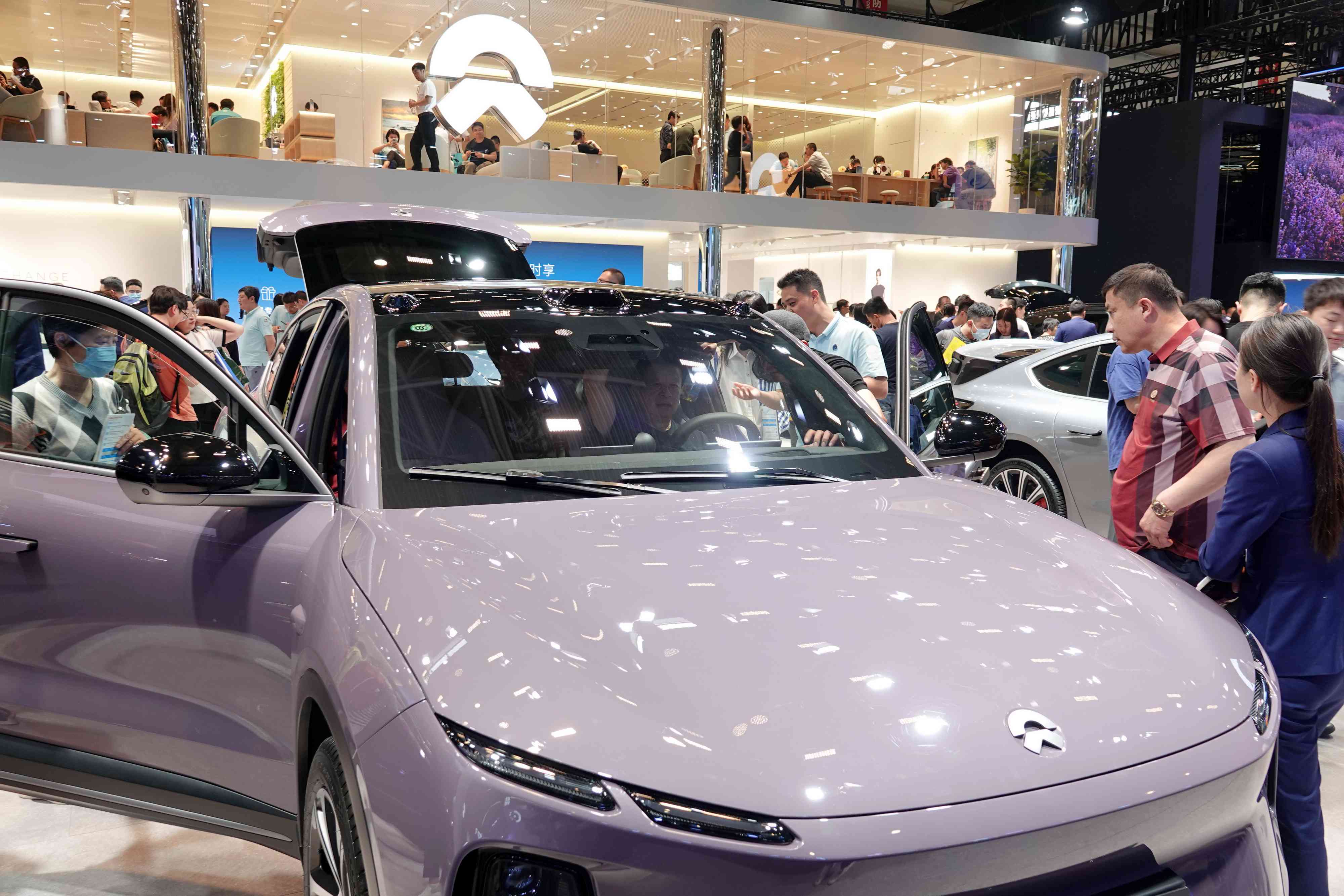 Visitors are looking at NIO electric cars at the 2024 Beijing International Automotive Exhibition in Beijing, China, on May 3, 2024