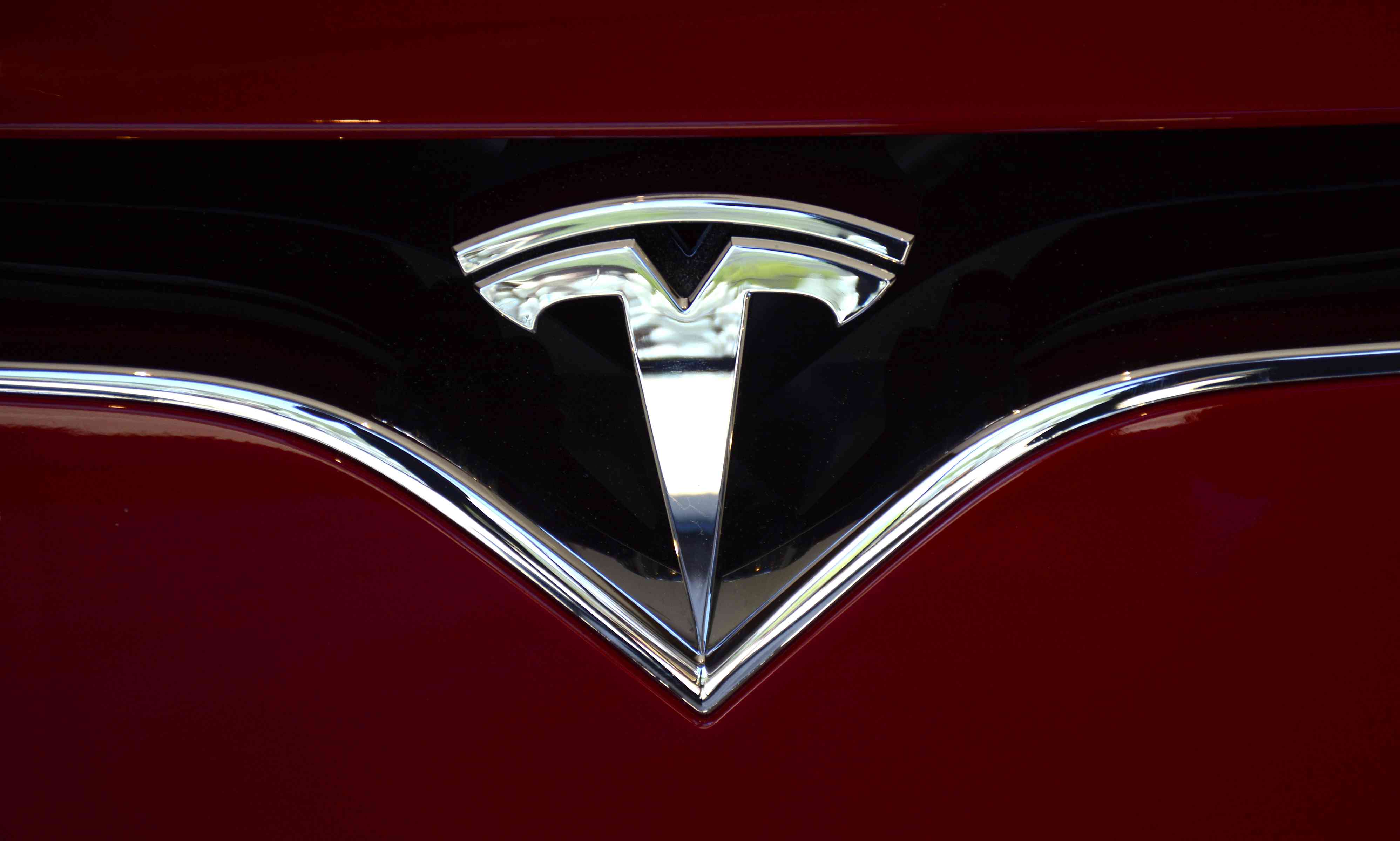 The Tesla brand logo on one of the company's cares. 