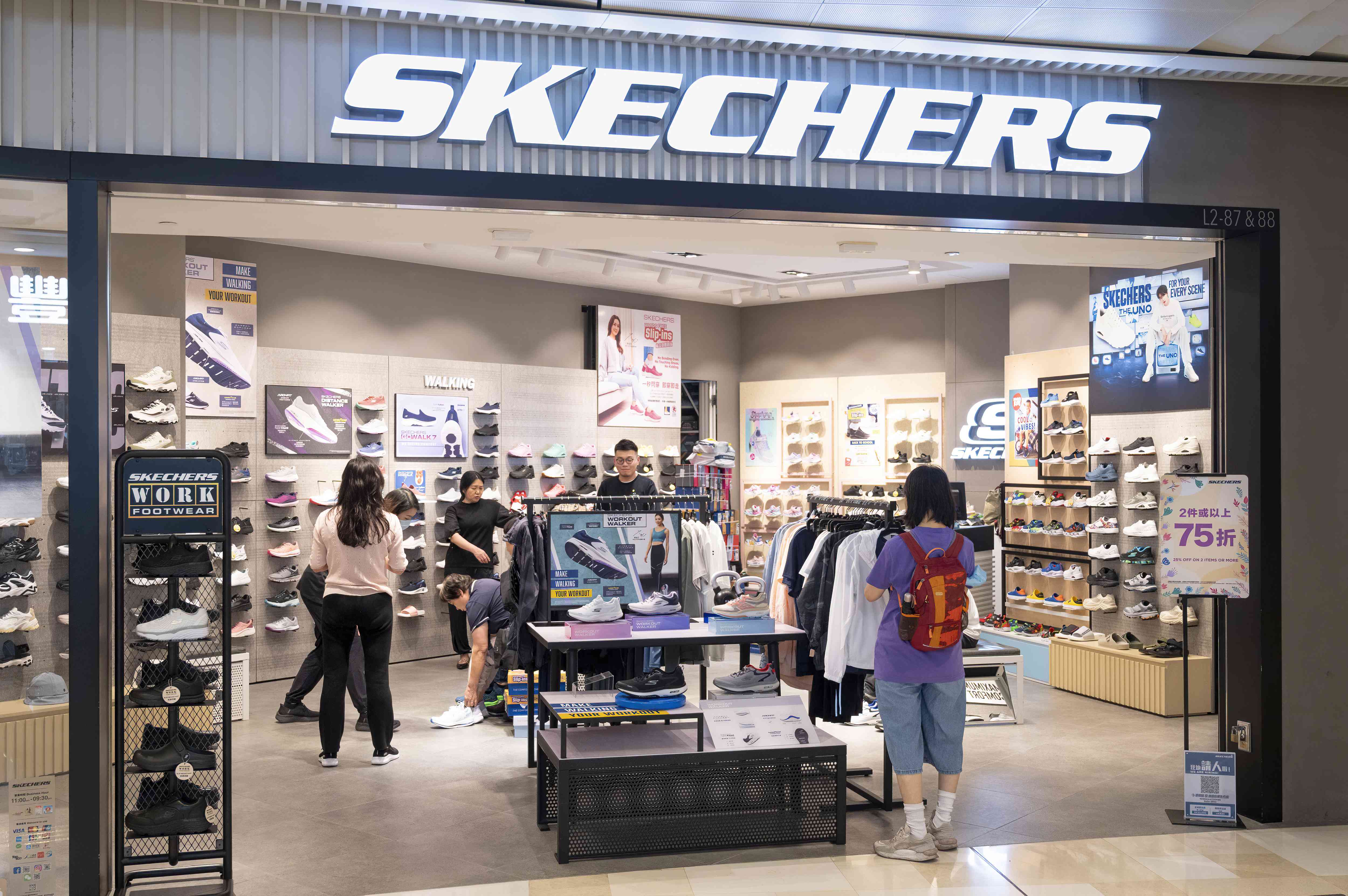 Customers are seen at the American lifestyle and performance footwear brand Skechers store in Hong Kong