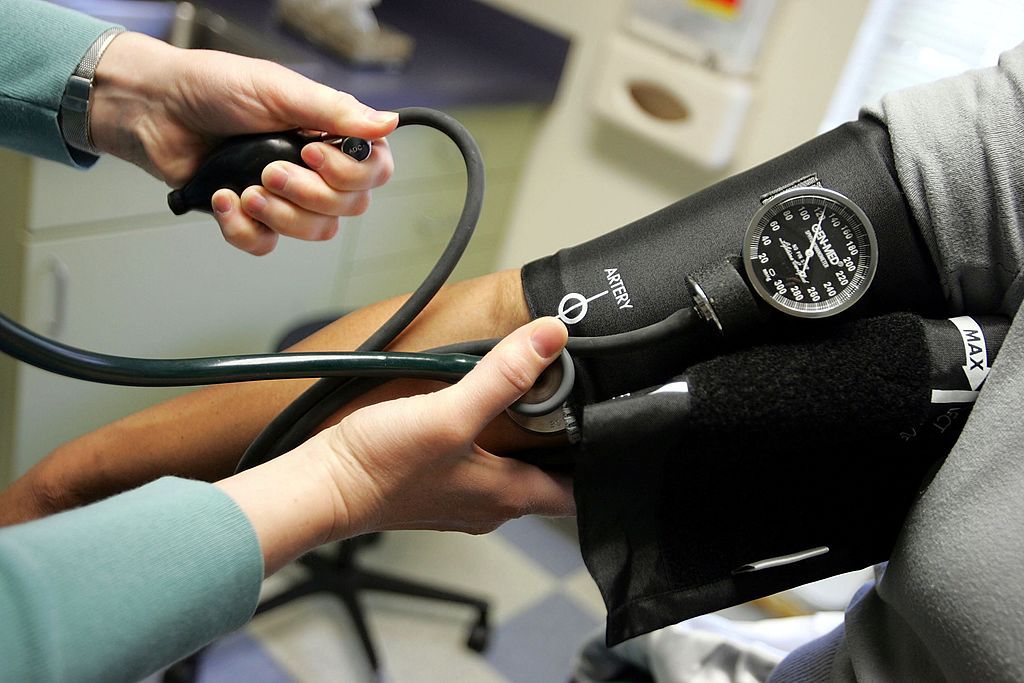 Dr. Elizabeth Maziarka reads a blood pressure gauge during an examination of patient June Mendez at the Codman Square Health Center in Dorchester, Massachusetts. 