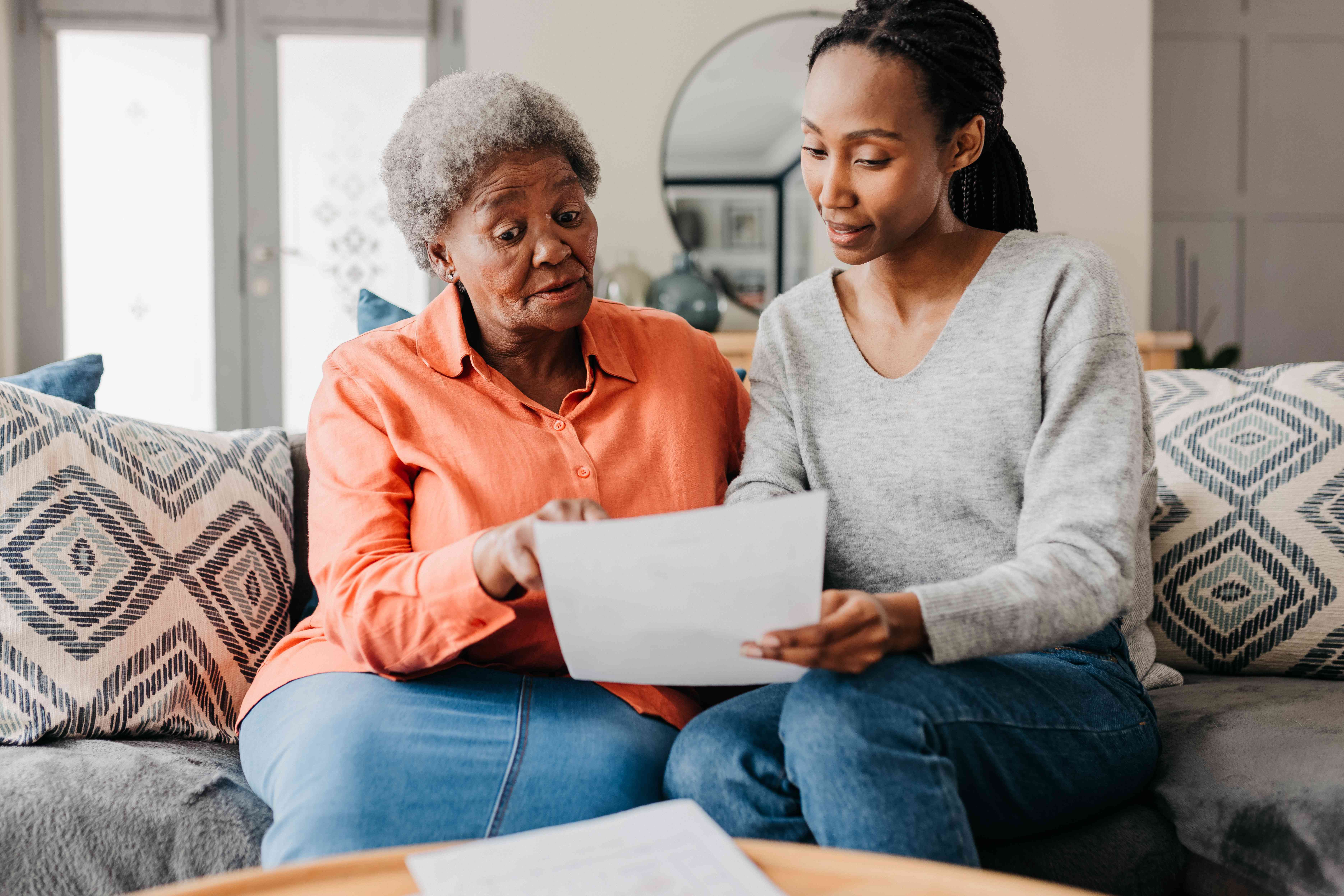 Woman showing a document to an elderly woman