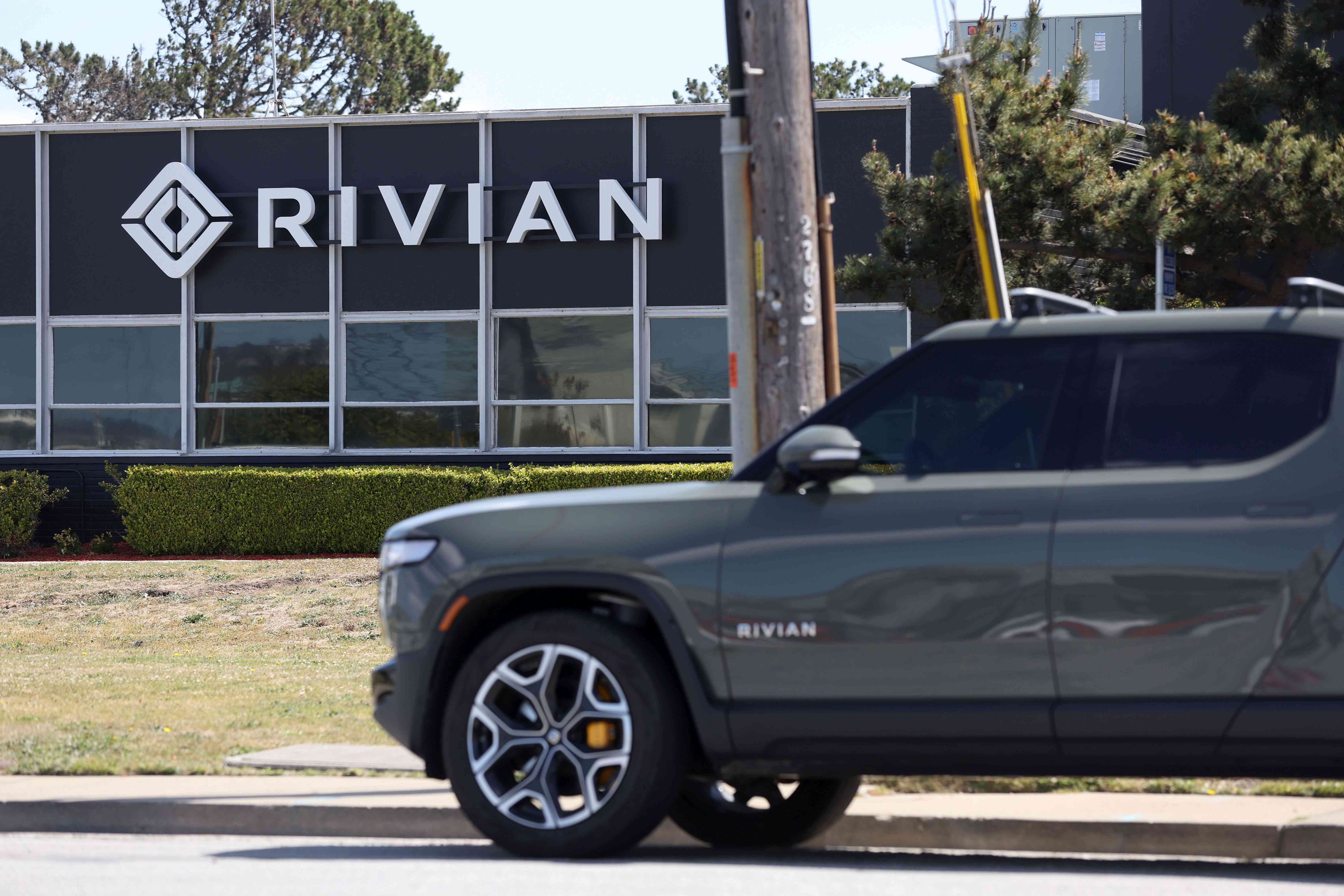 A Rivian electric pickup truck outside a Rivian service center