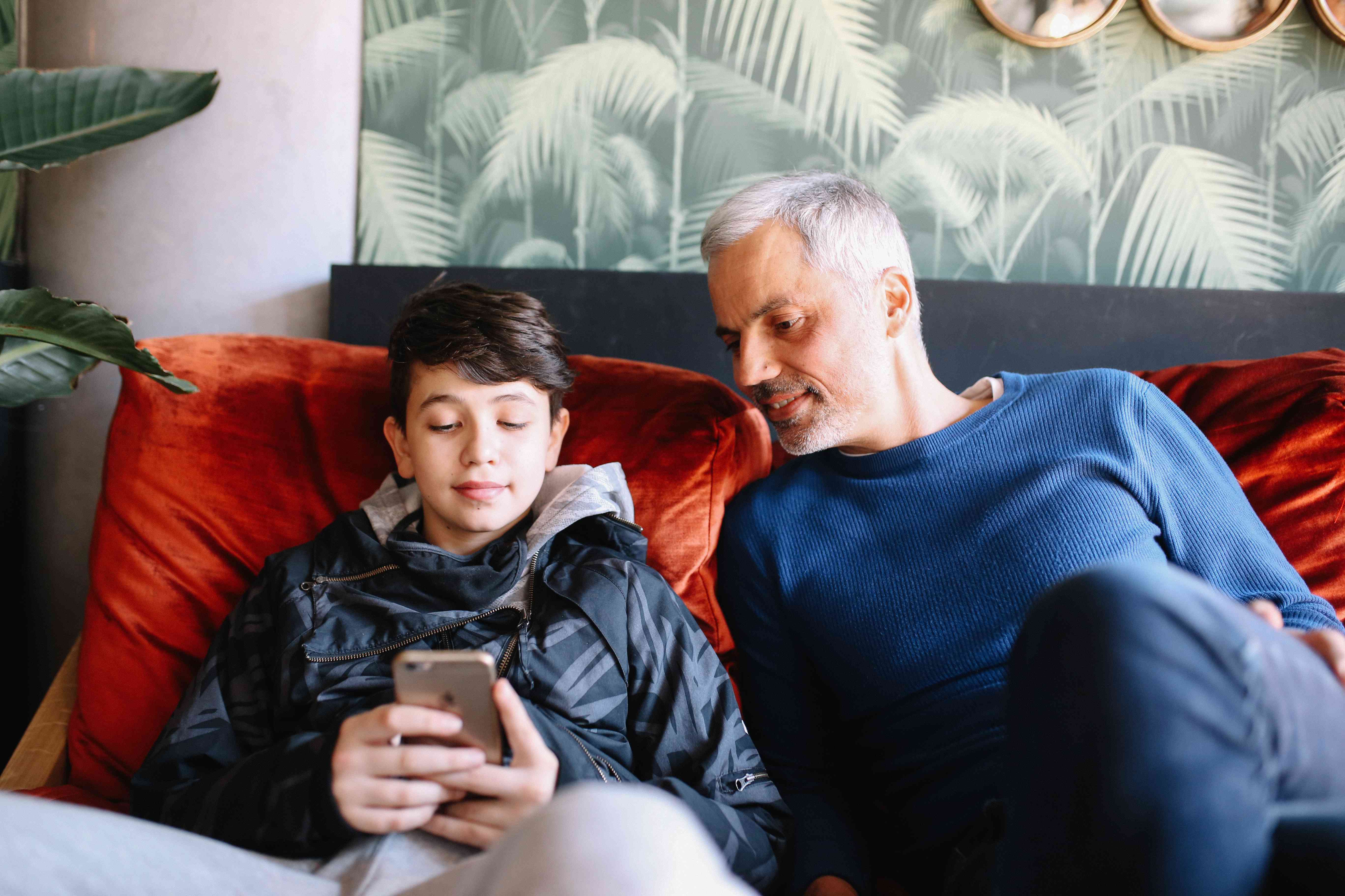 parent and son looking at iPhone