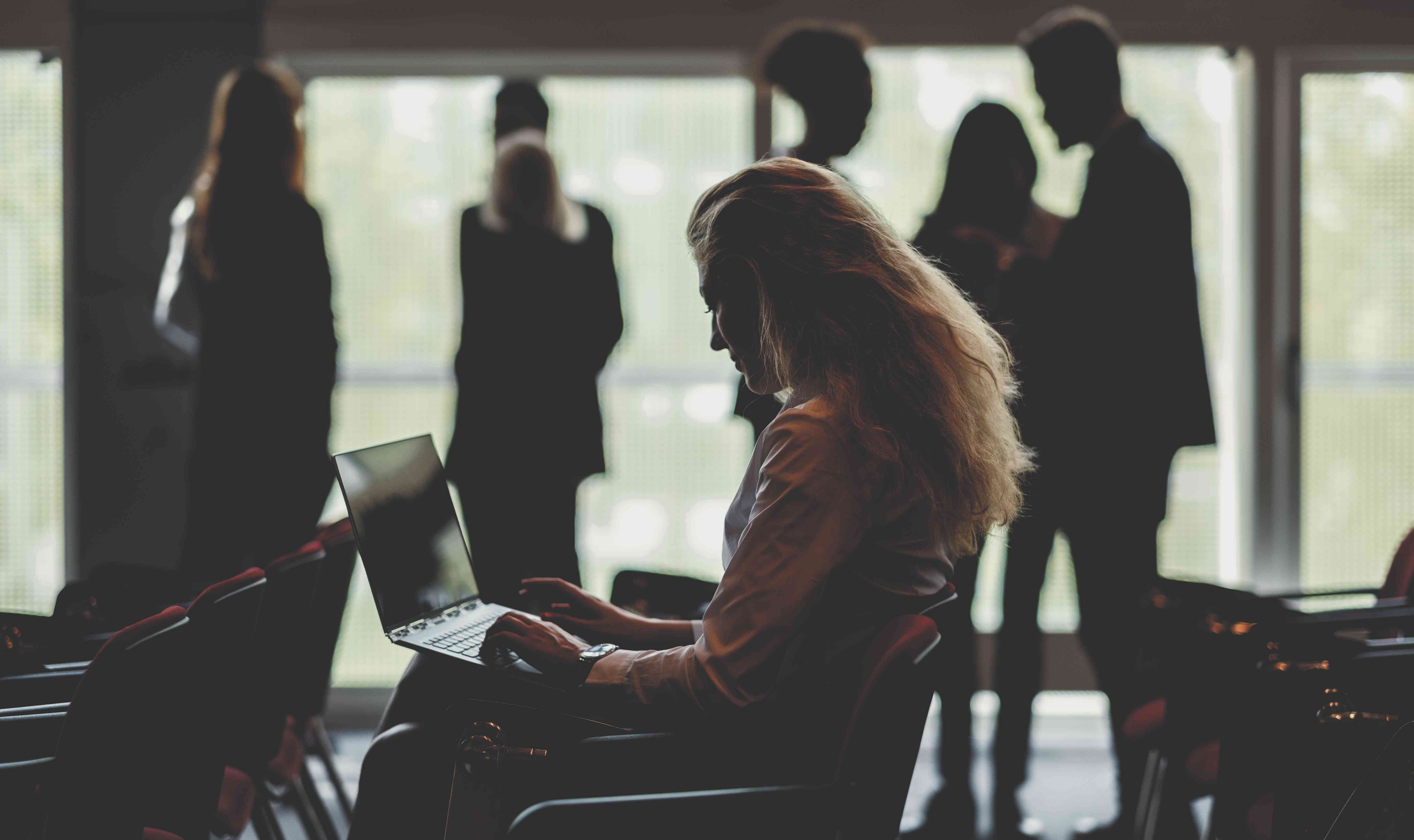 Businesswoman using laptop in conference room