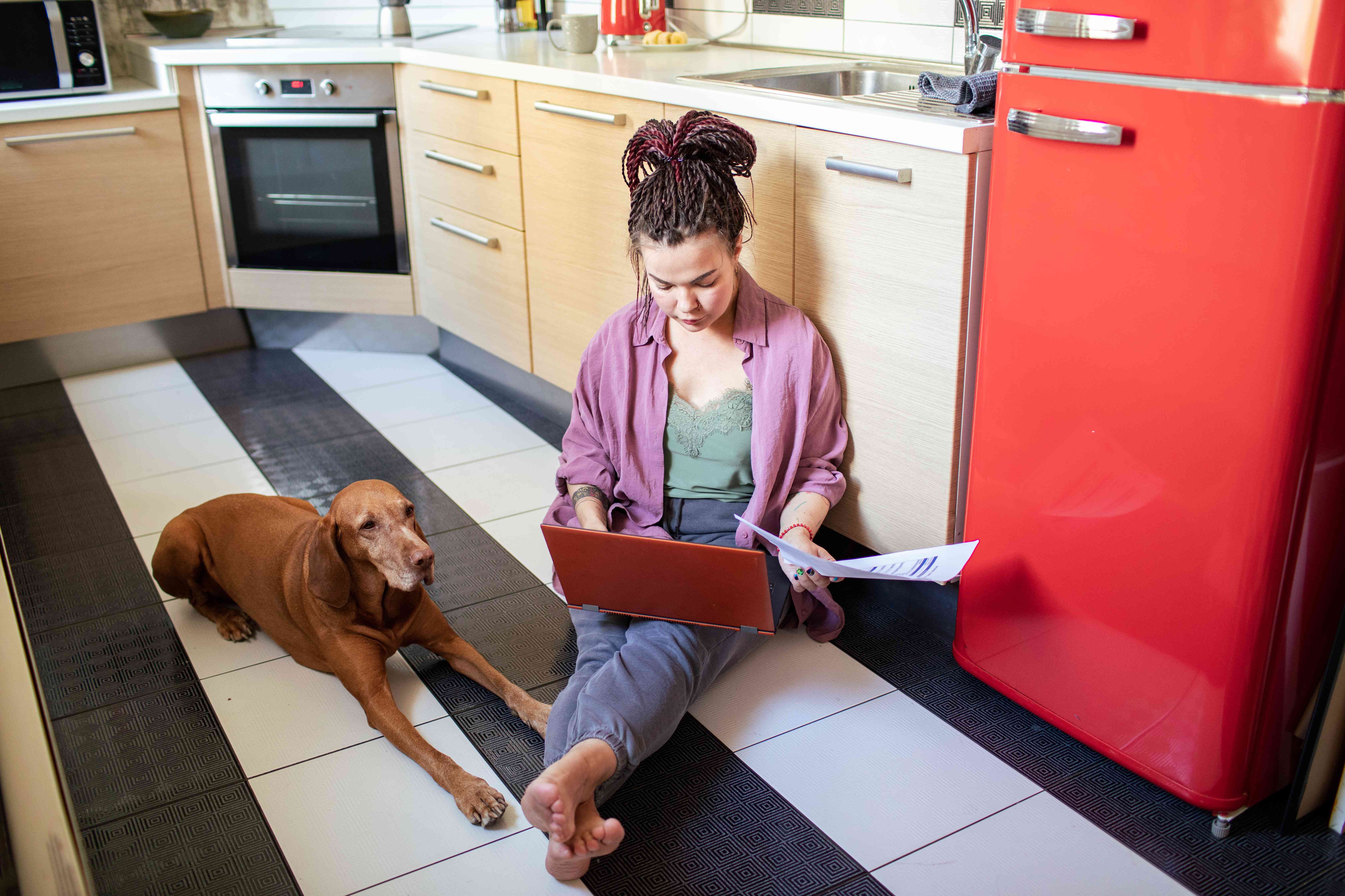 Young adult checking saving account balance on laptop