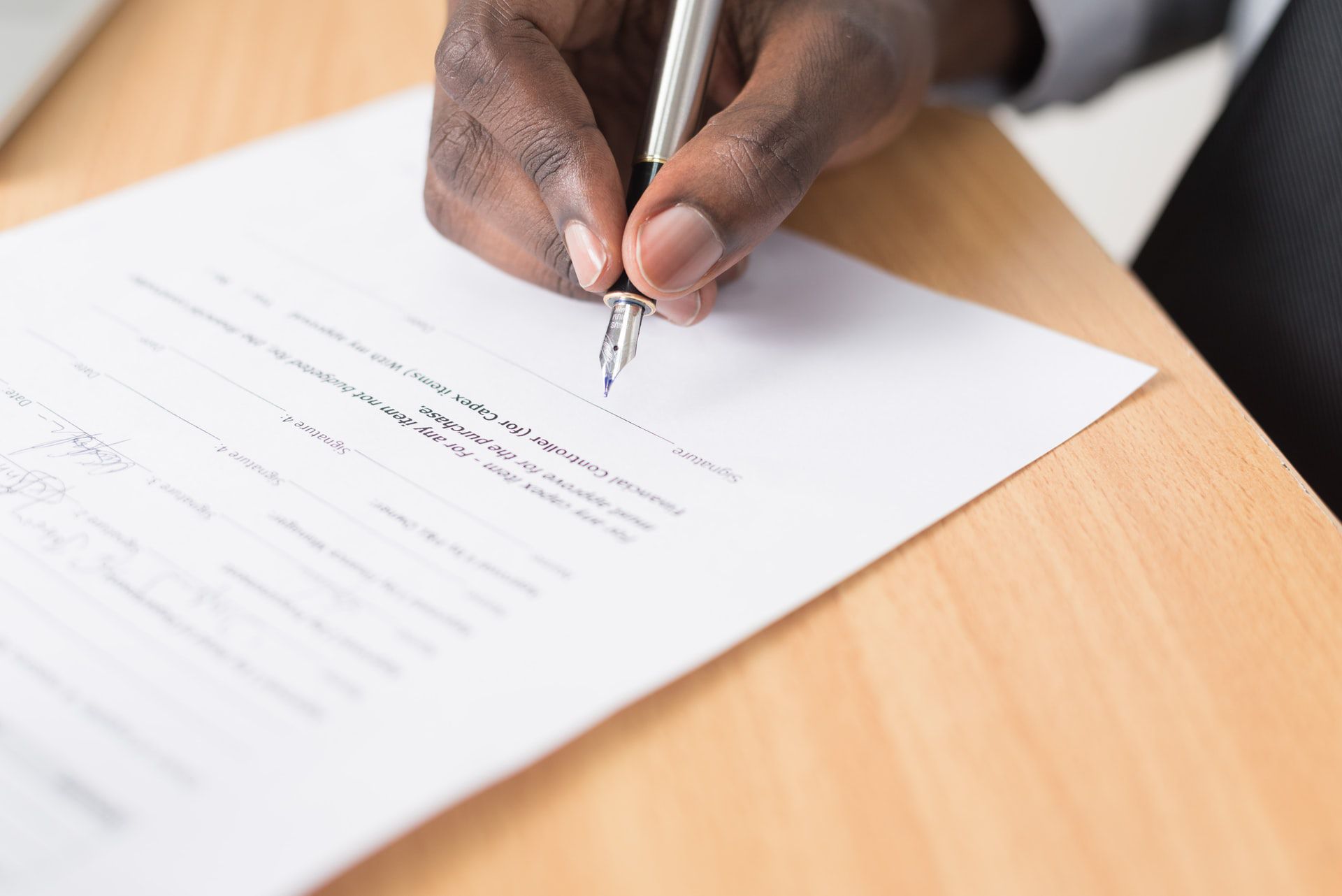 Person about to sign a document