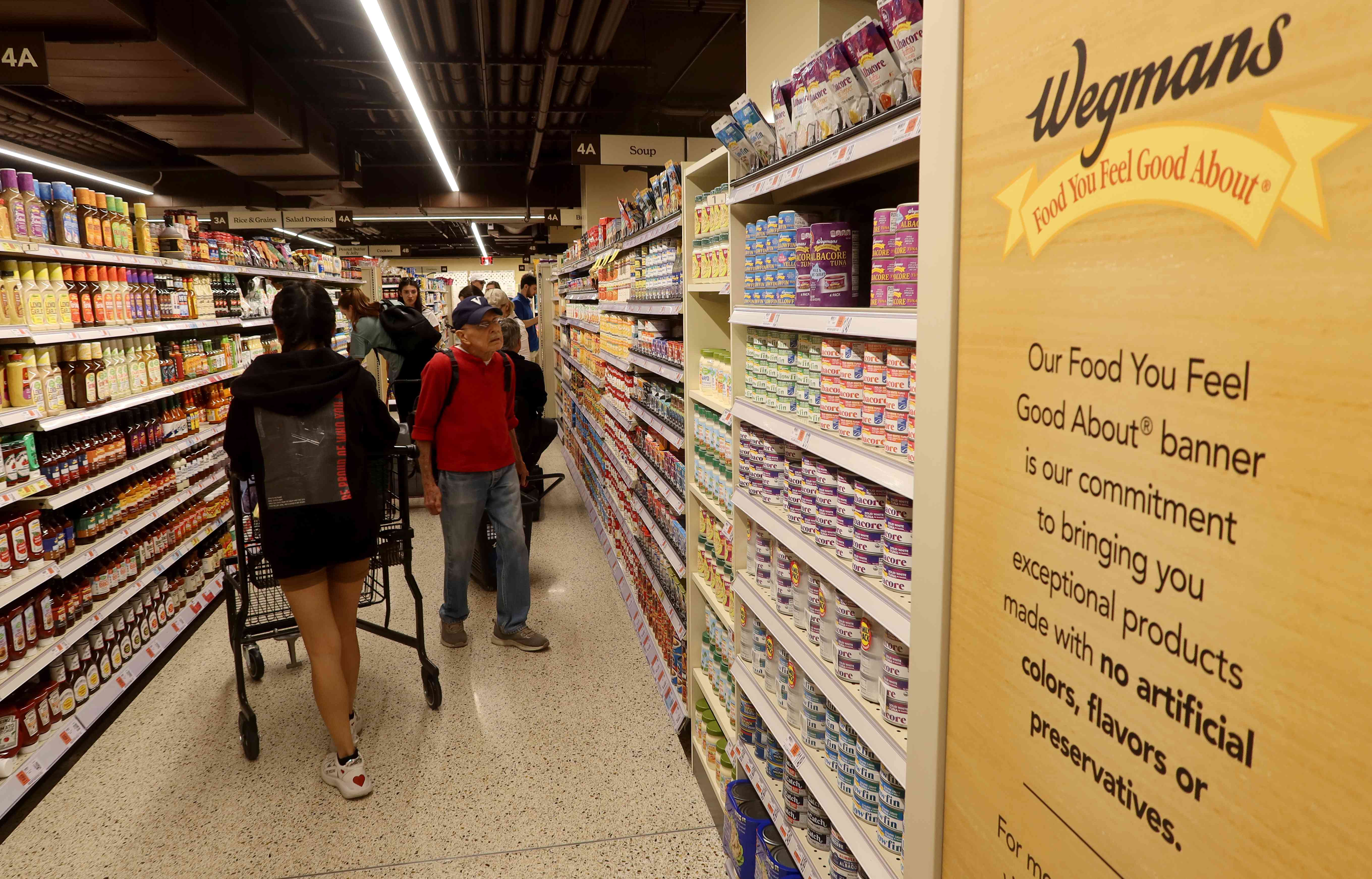 People shop at the new Wegmans Astor Place grocery store on October 28, 2023, in New York City. 