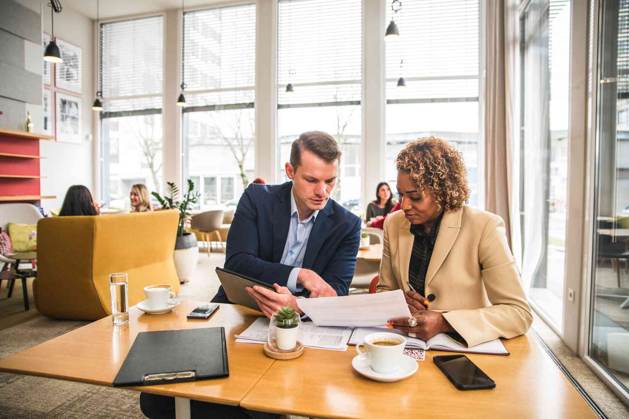 Diverse business partners sitting in a cafe having a meeting. Discussing future business ideas while drinking coffee.