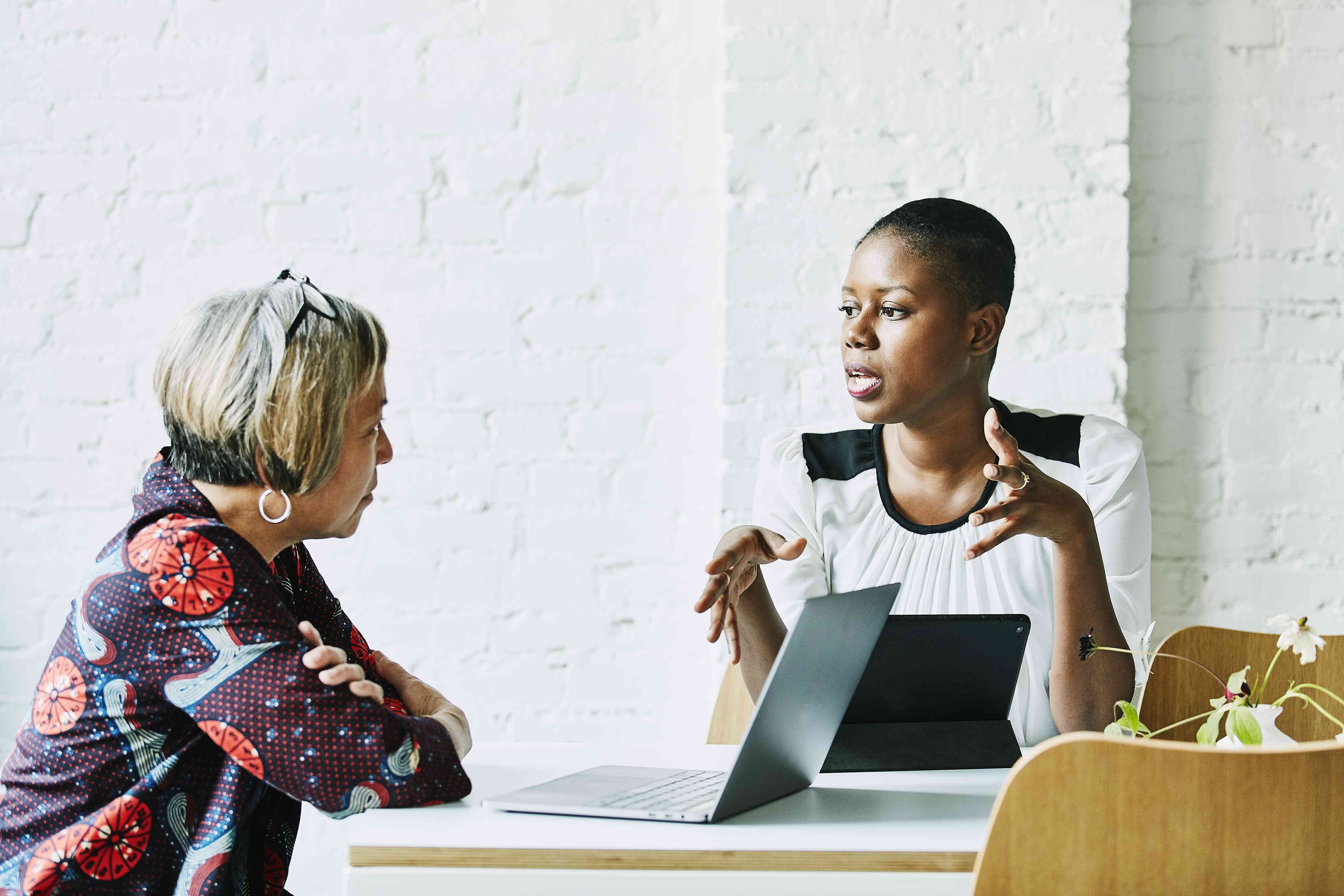 Financial advisor in discussion with client in office conference room.