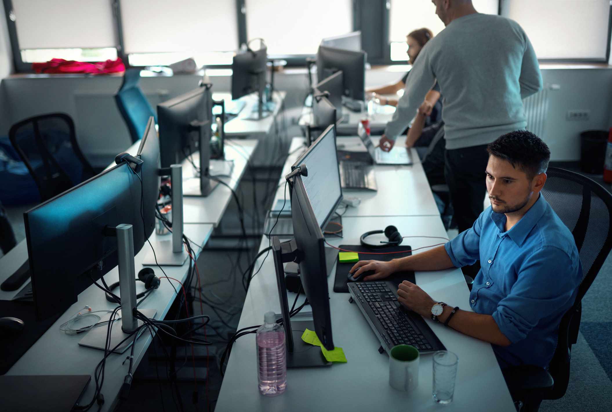 A man at work on computers in an office