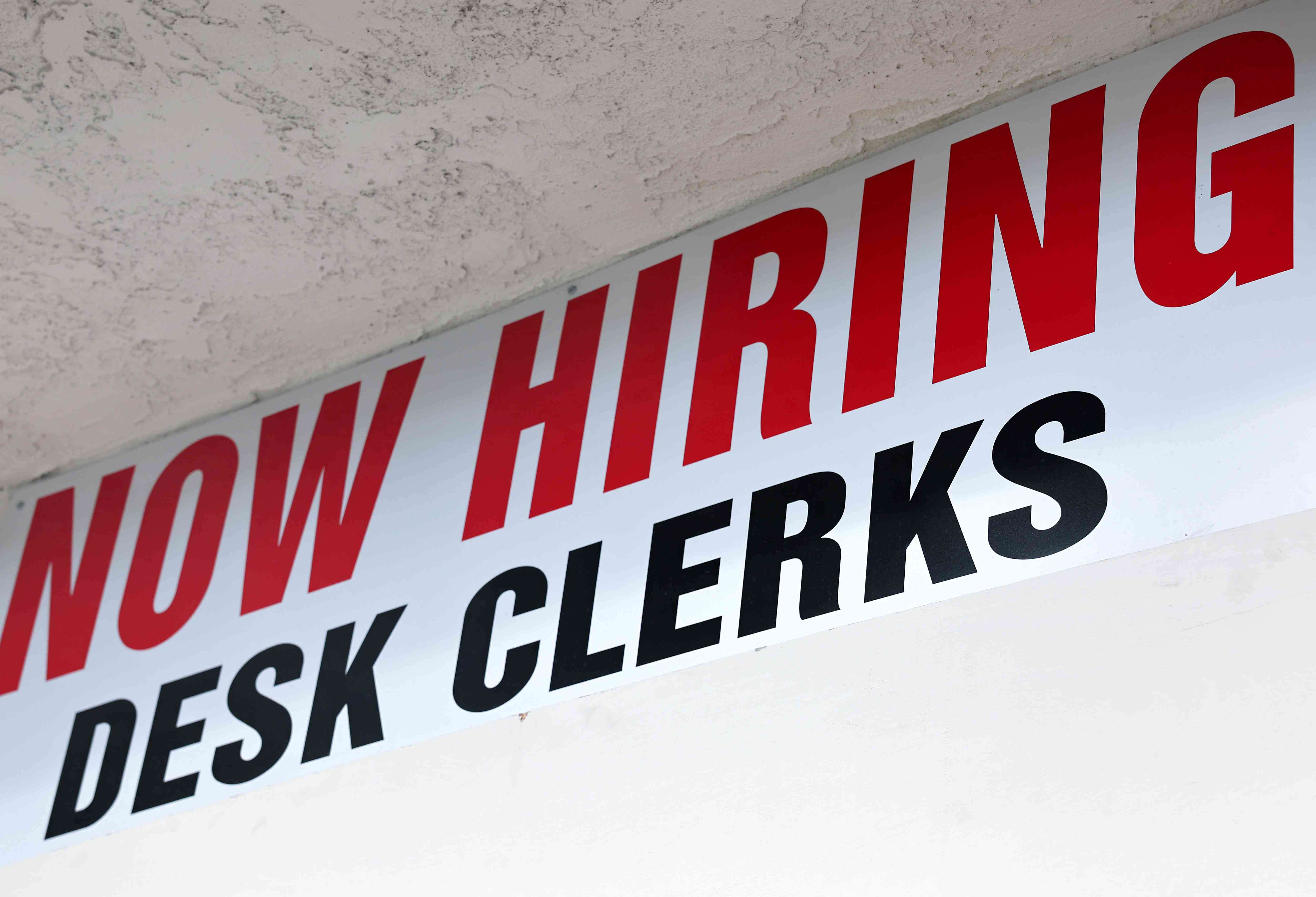 A 'Now Hiring' sign is posted outside a hotel in Los Angeles, California 