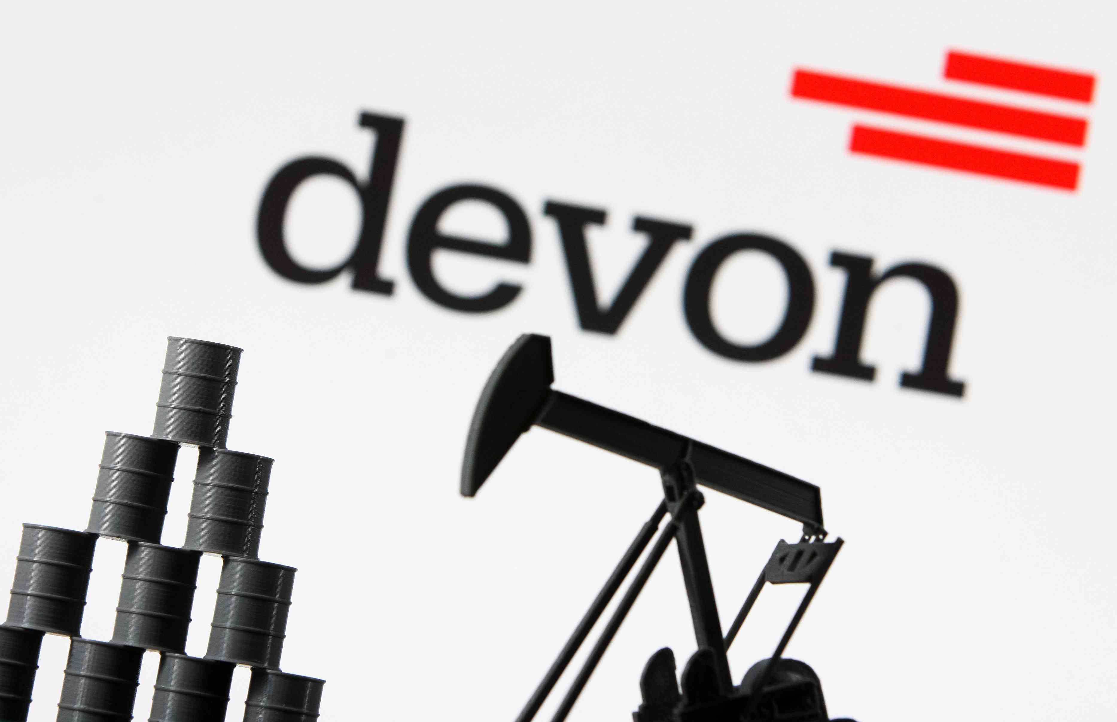 Devon Energy Corporation company logo and miniature models of an oil derrick pump and oil barrels 