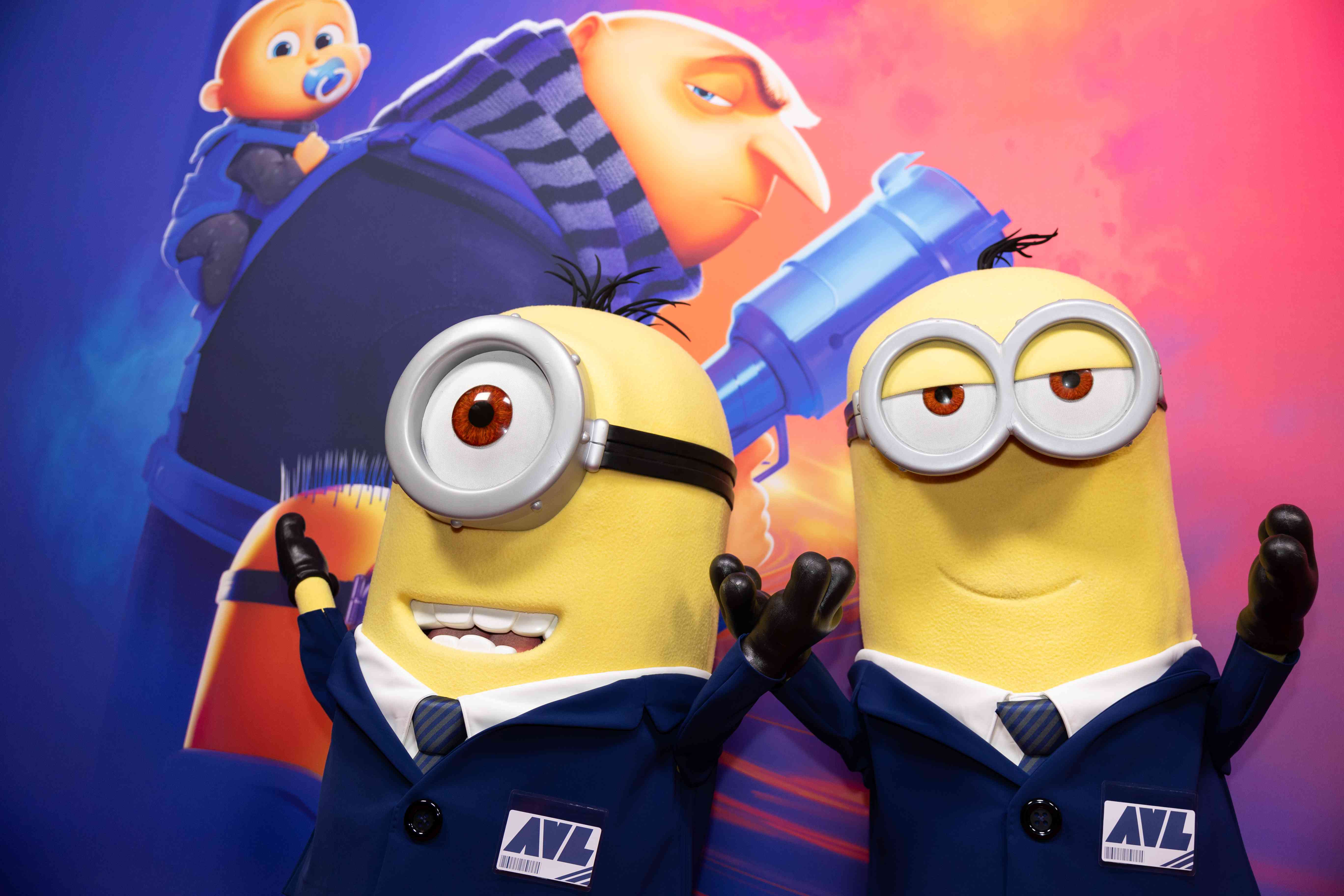 Two life-size "minions" promote the film "Despicable Me 4" at an event in June. 