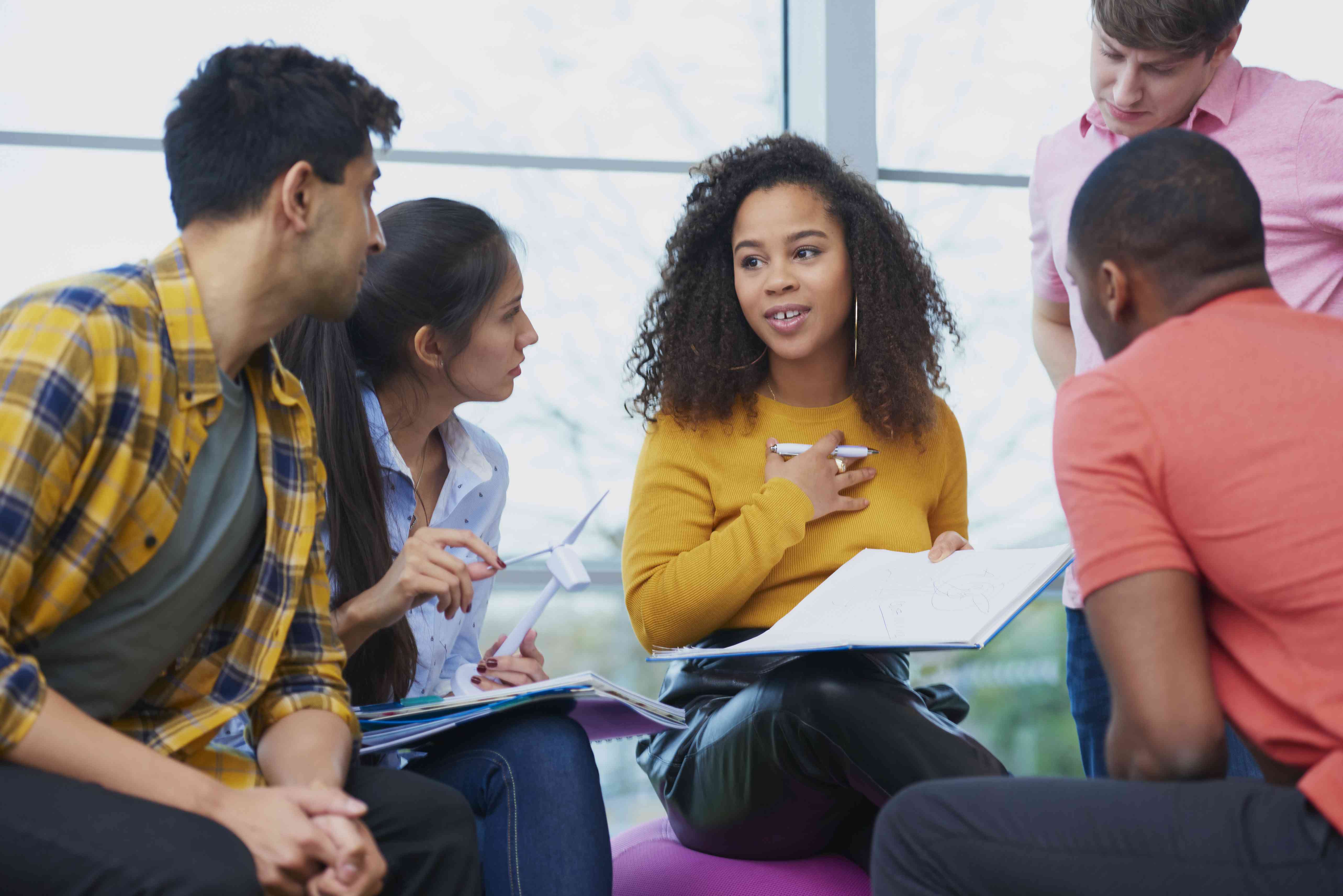 Group of friends talking about how to improve their credit scores despite their student loan debt