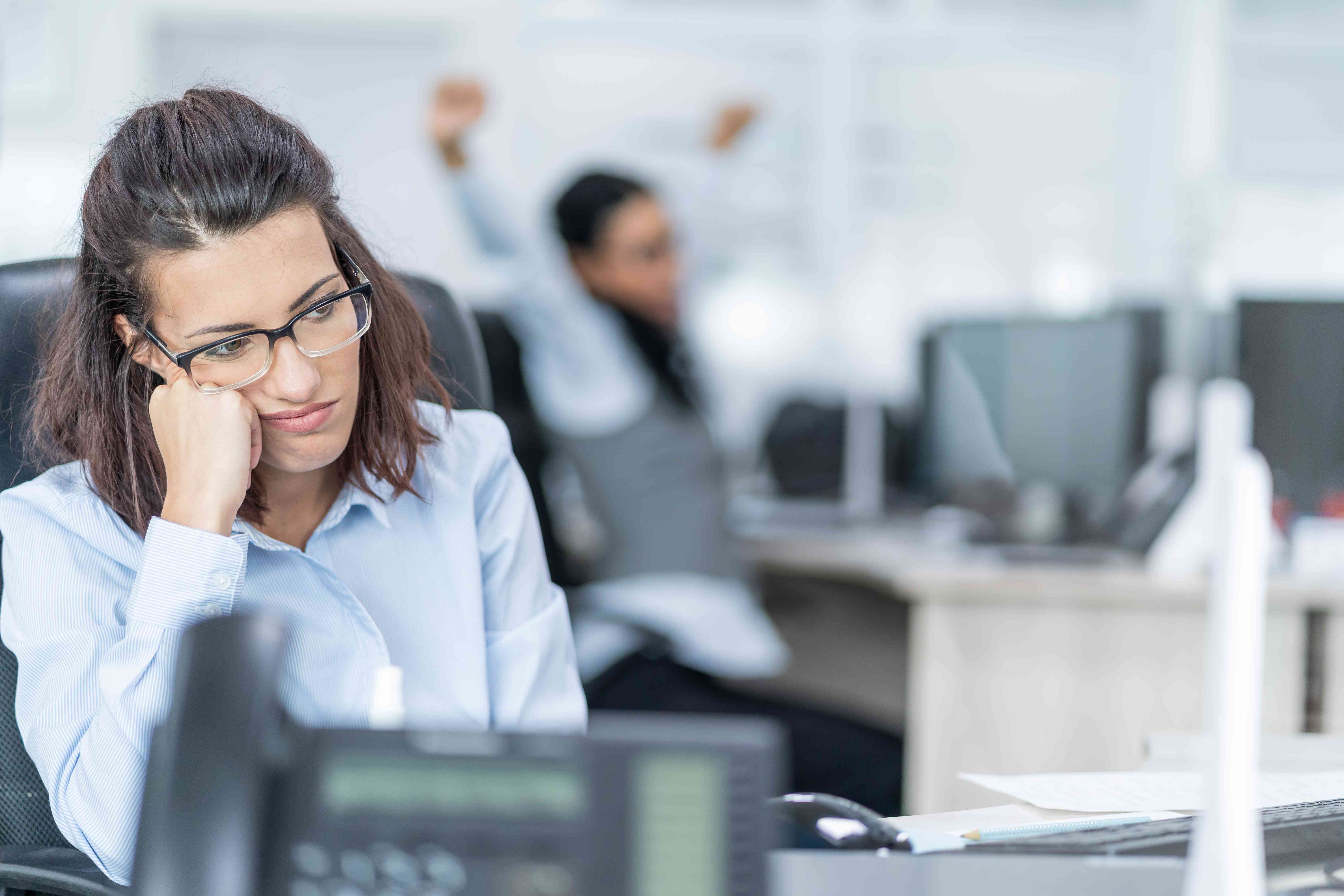 Stressed financial advisor looking on.