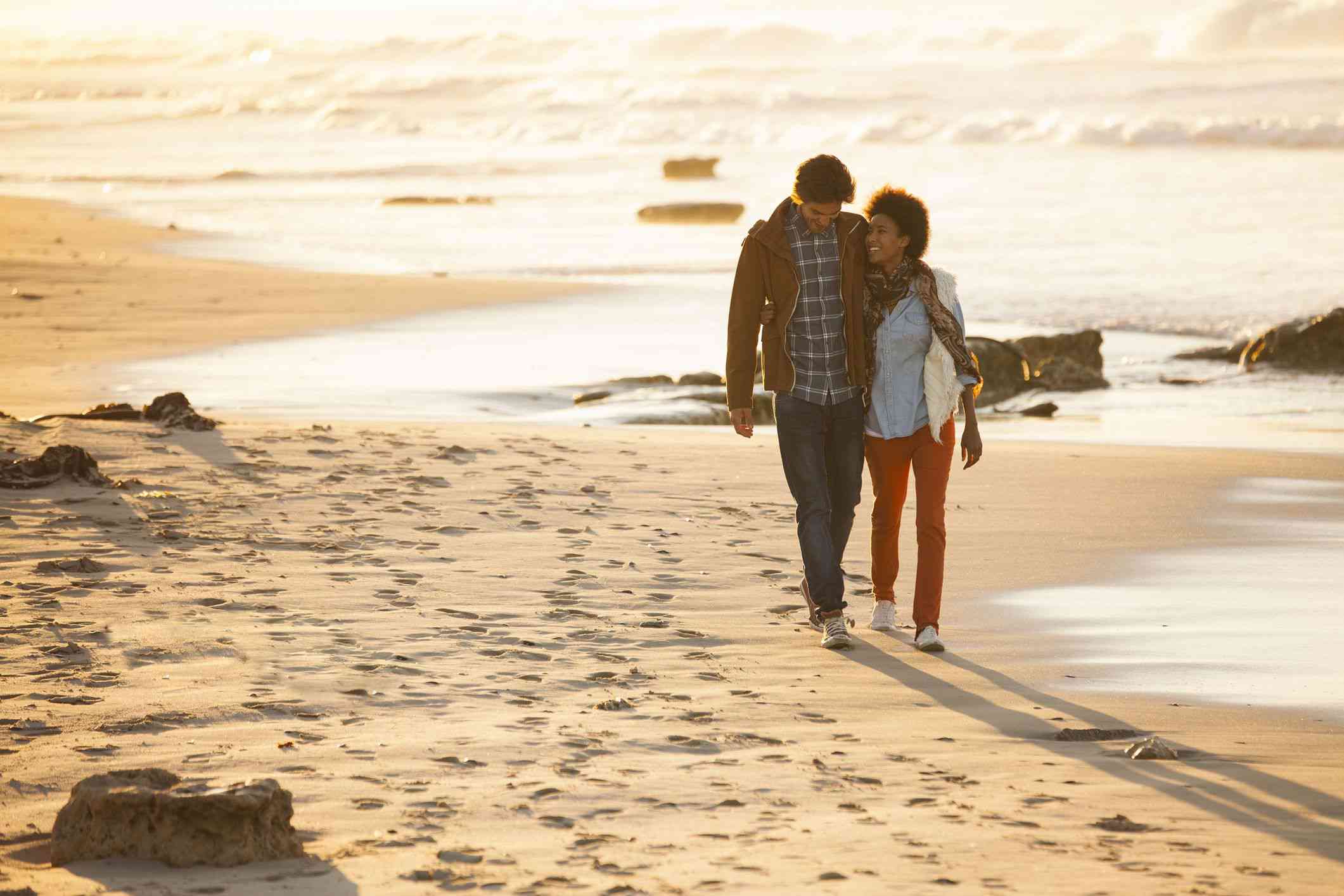 A couple walking on the beach.