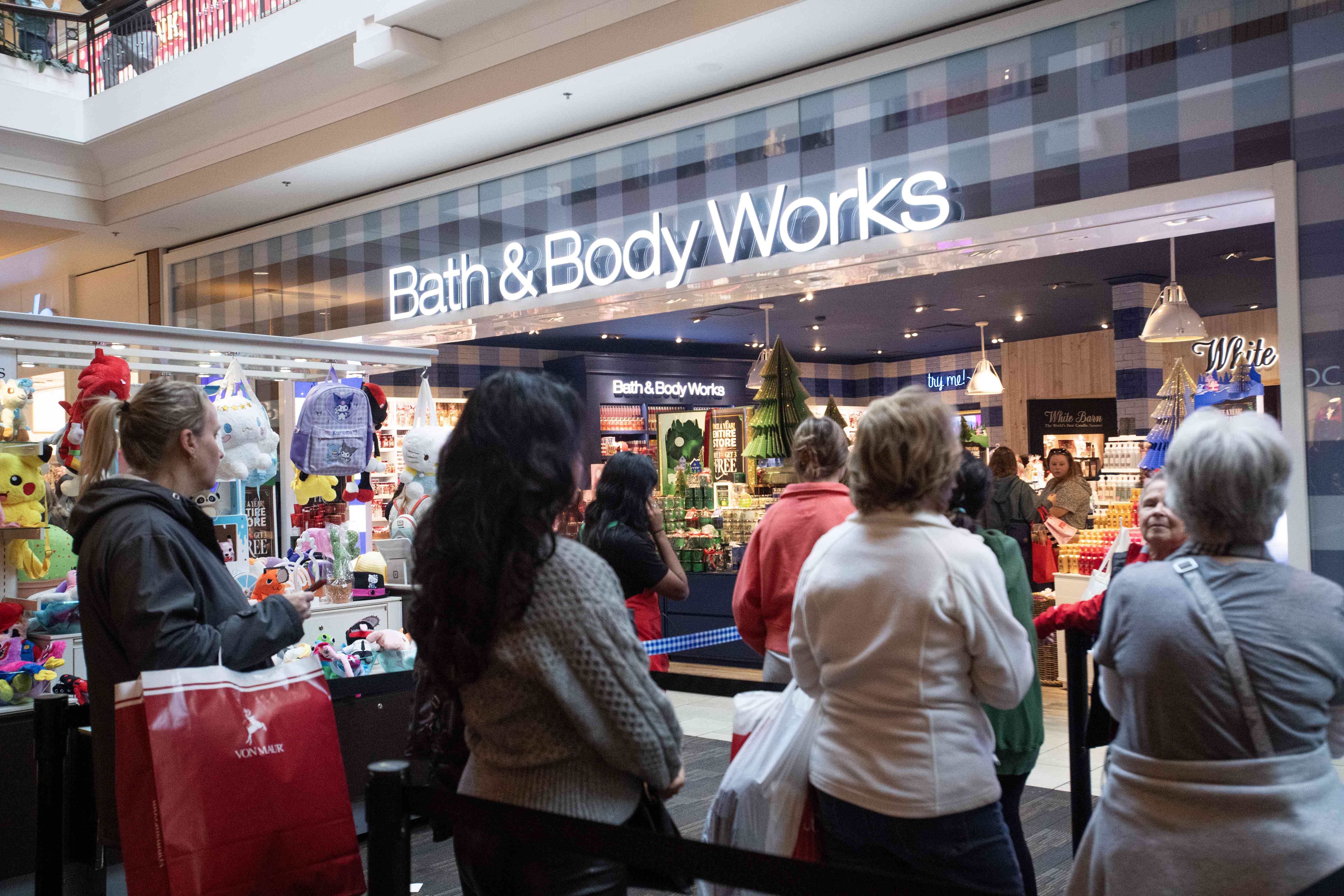 Shoppers wait in line in front of a Bath & Body Works store at the Polaris Fashion Place mall on Black Friday in Columbus, Ohio, on Nov. 24, 2023