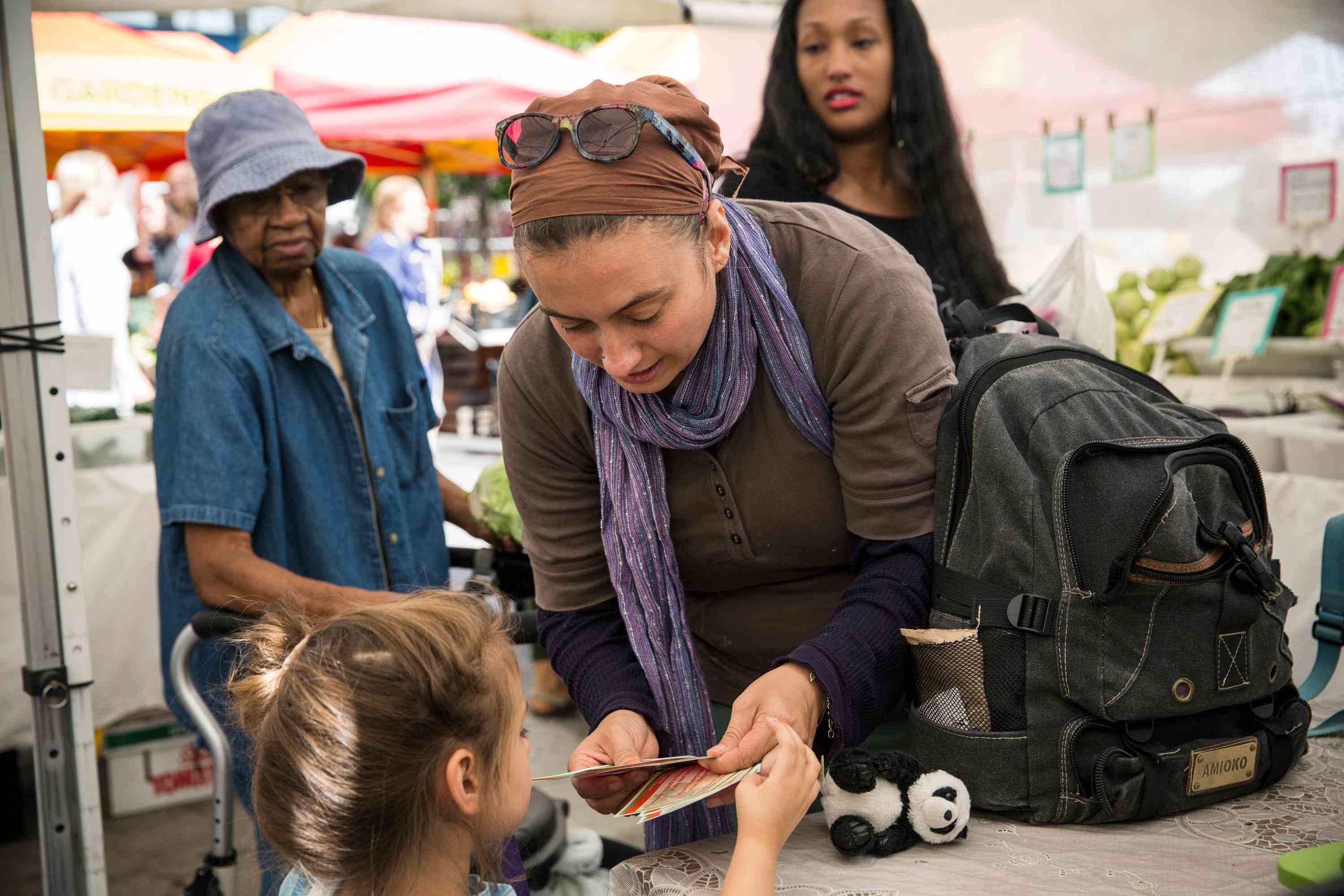 A white woman and her daughter shopping with EBT coupons, also known as food stamps, represent the largest racial group that benefits from SNAP in the U.S.