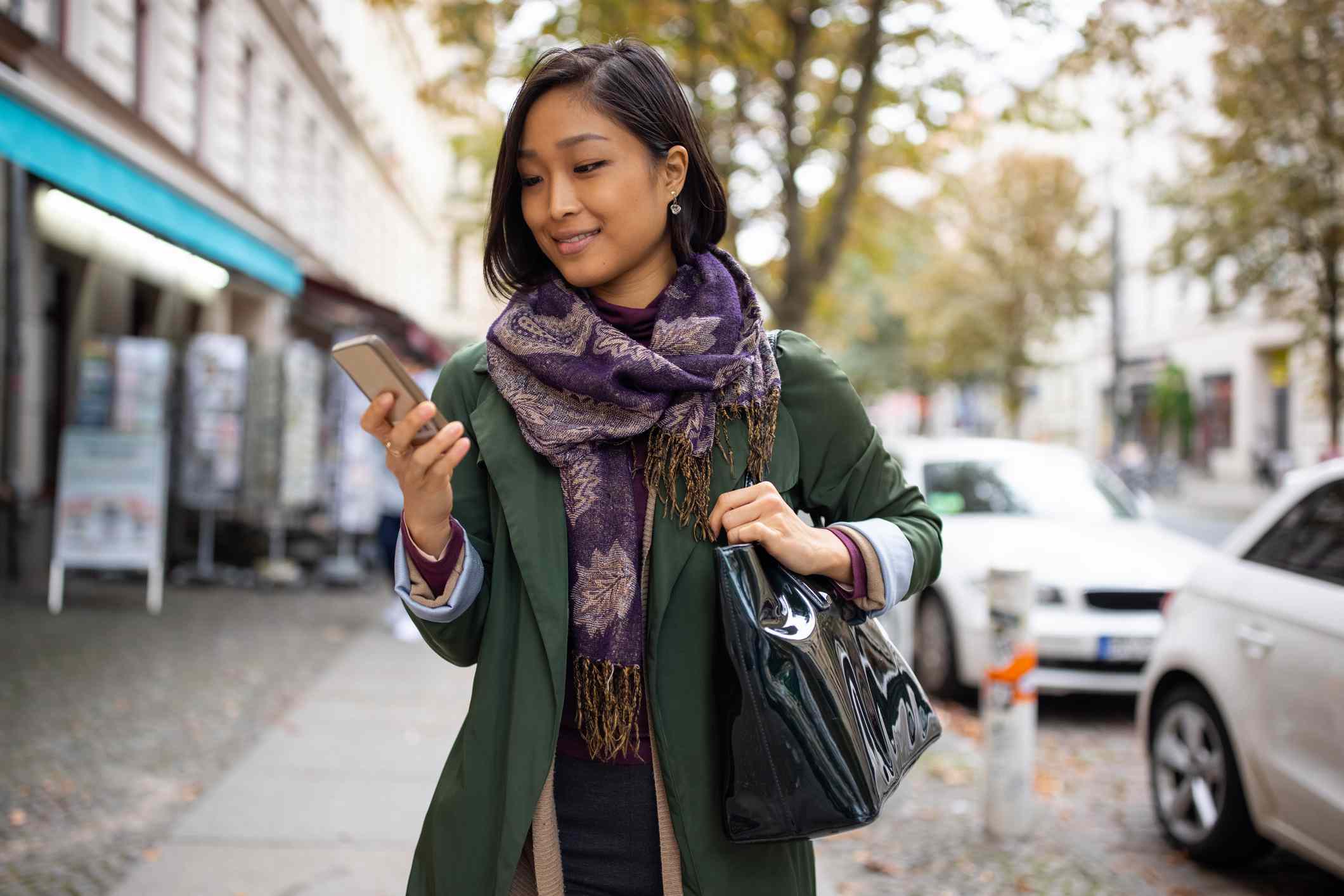 A woman uses her smartphone to access her investment robo-advisor.