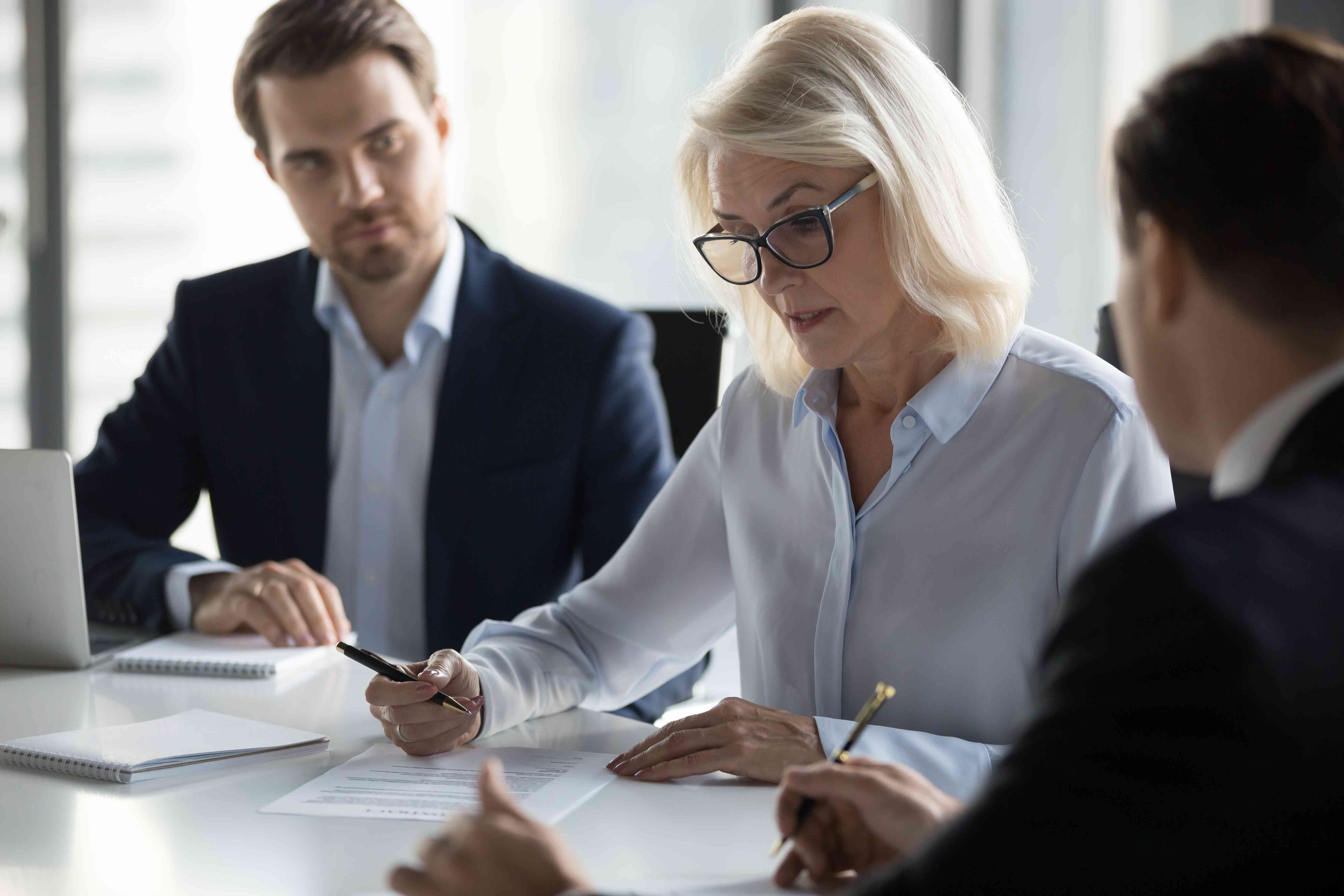 Woman signs debt consolidation loan paperwork