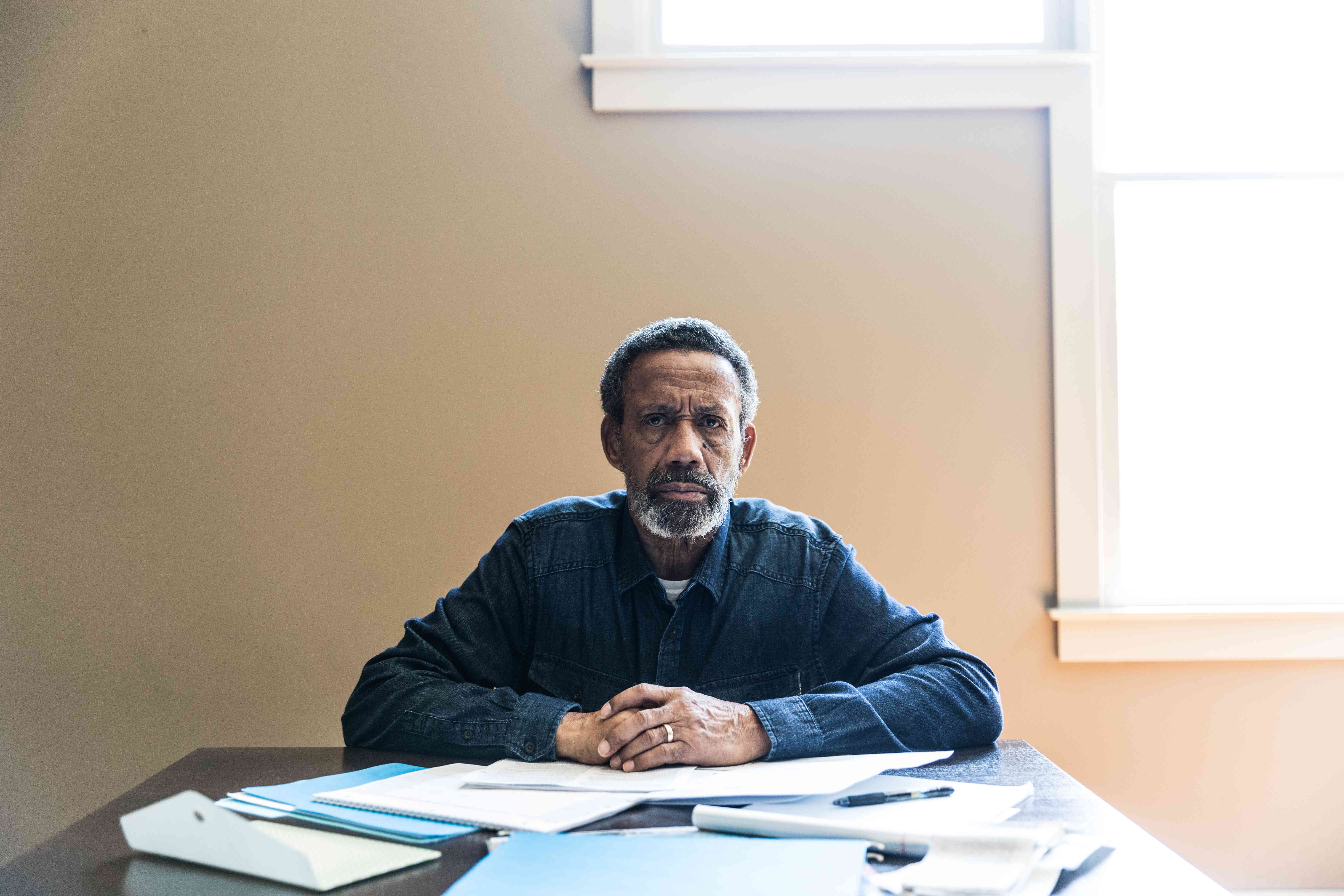 Portrait of senior man paying bills at home