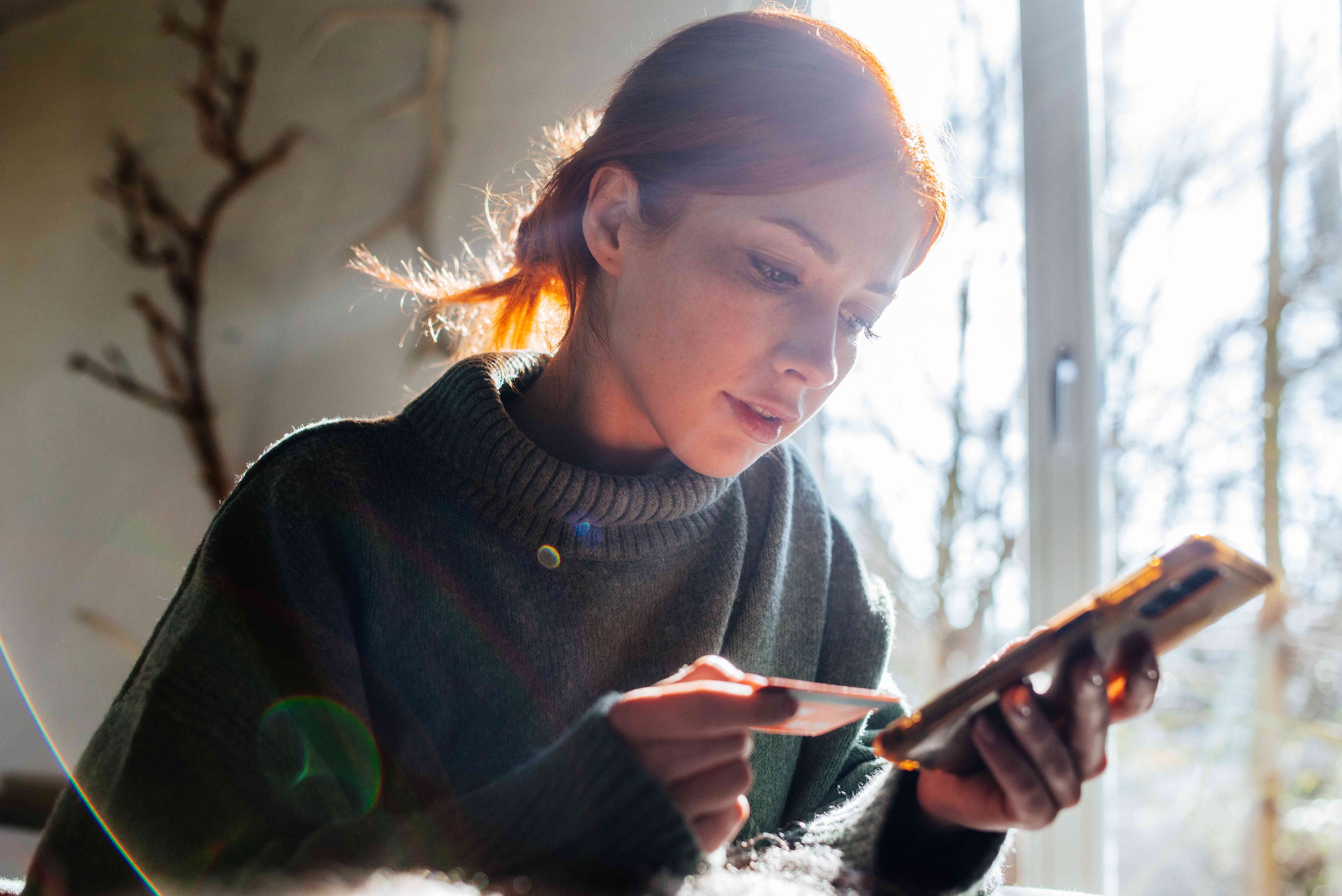 A woman shopping online with a card