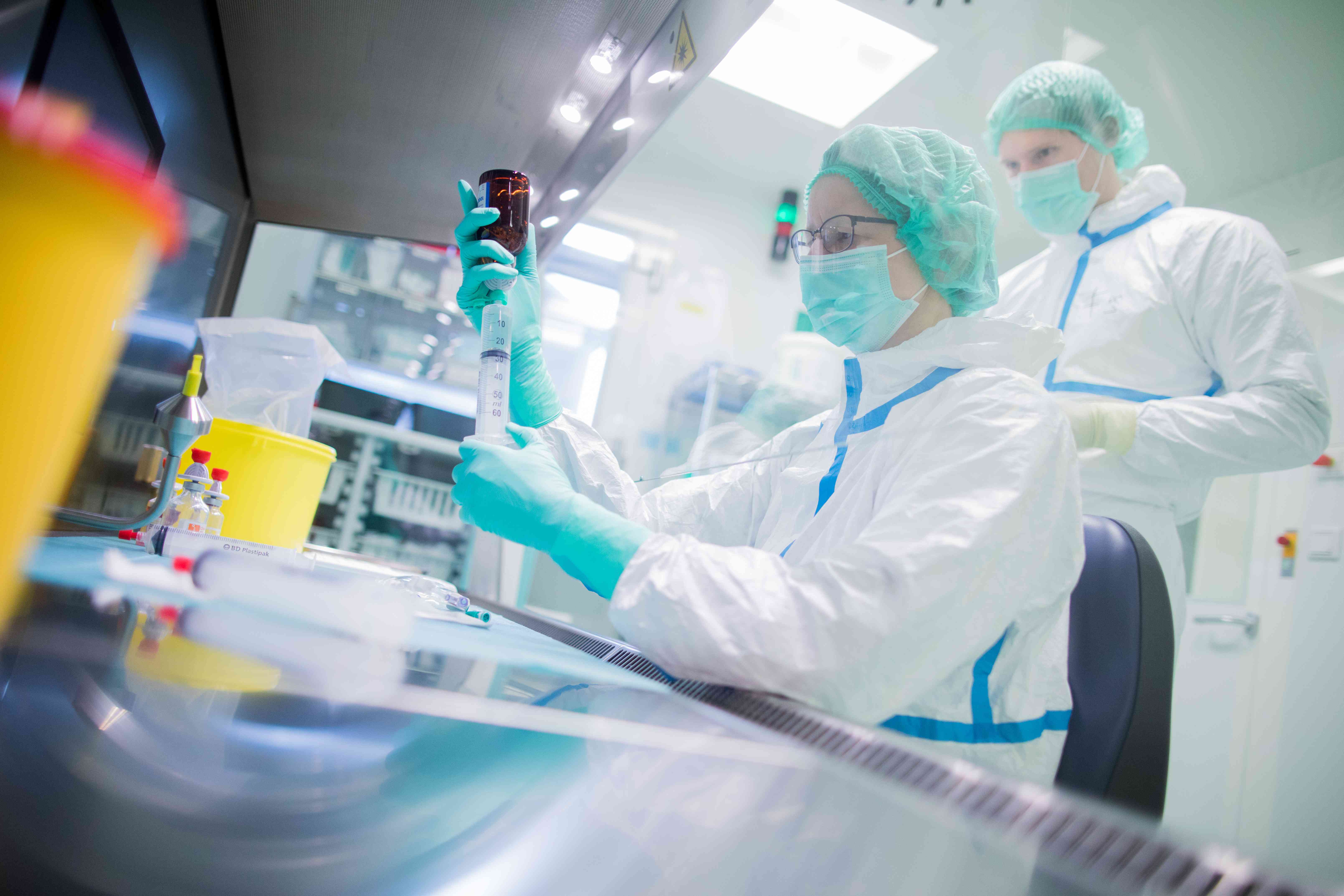 A pharmaceutical technical assistant and a pharmacist produce cancer drugs 