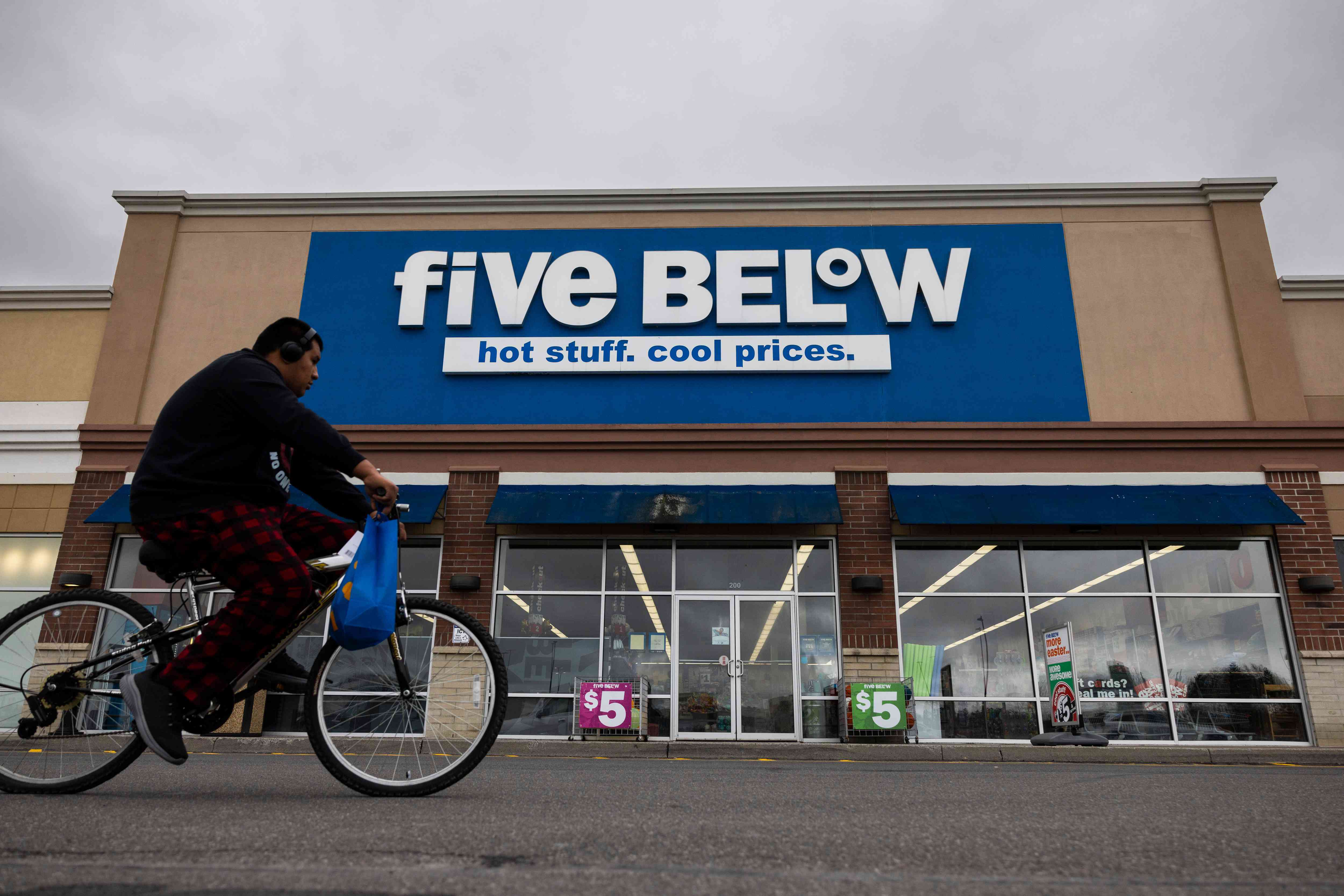 A cyclist passes a Five Below store in Hudson, New York, on March 15, 2024