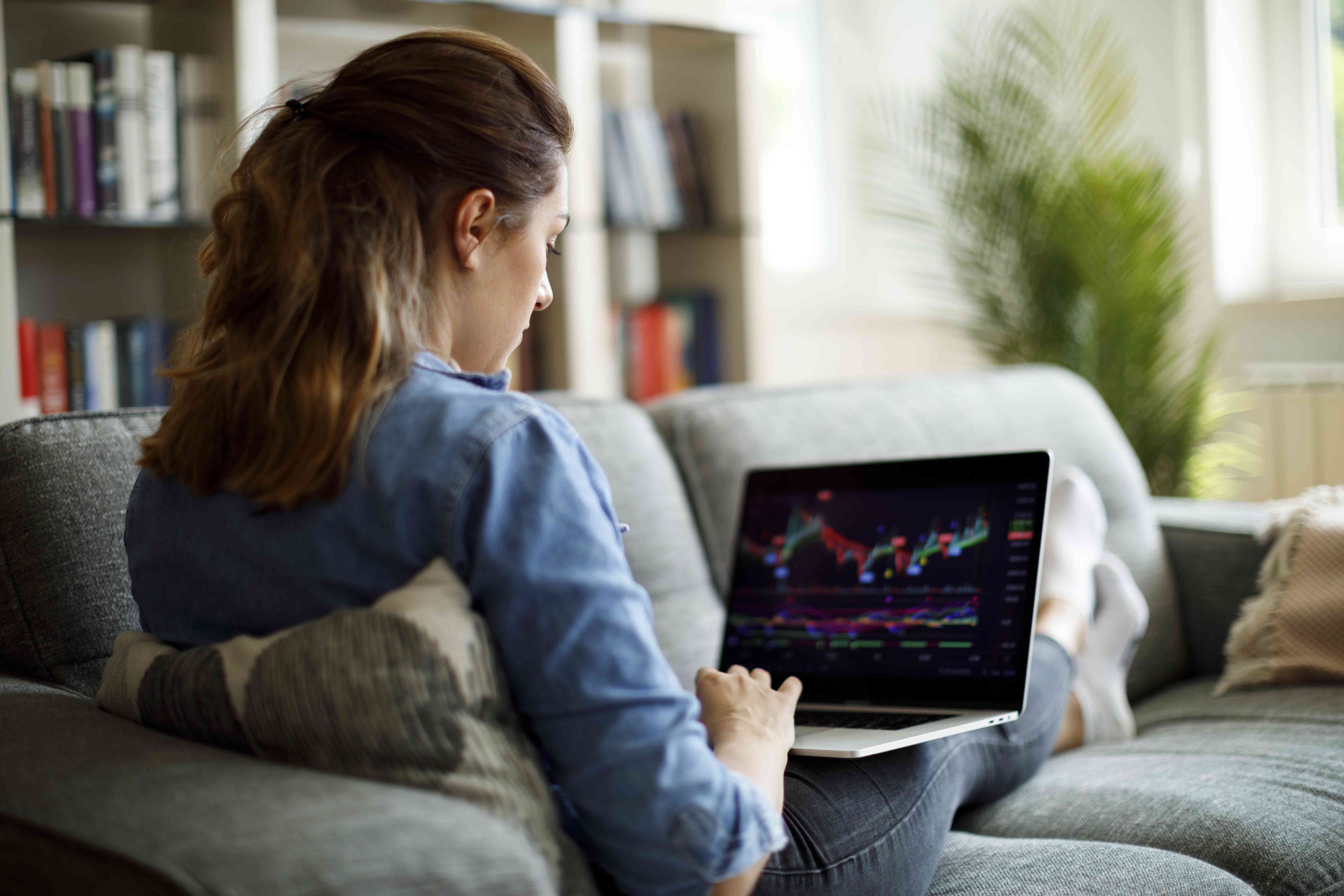 Woman trading on laptop