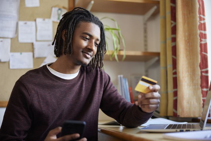 Man looking at credit card