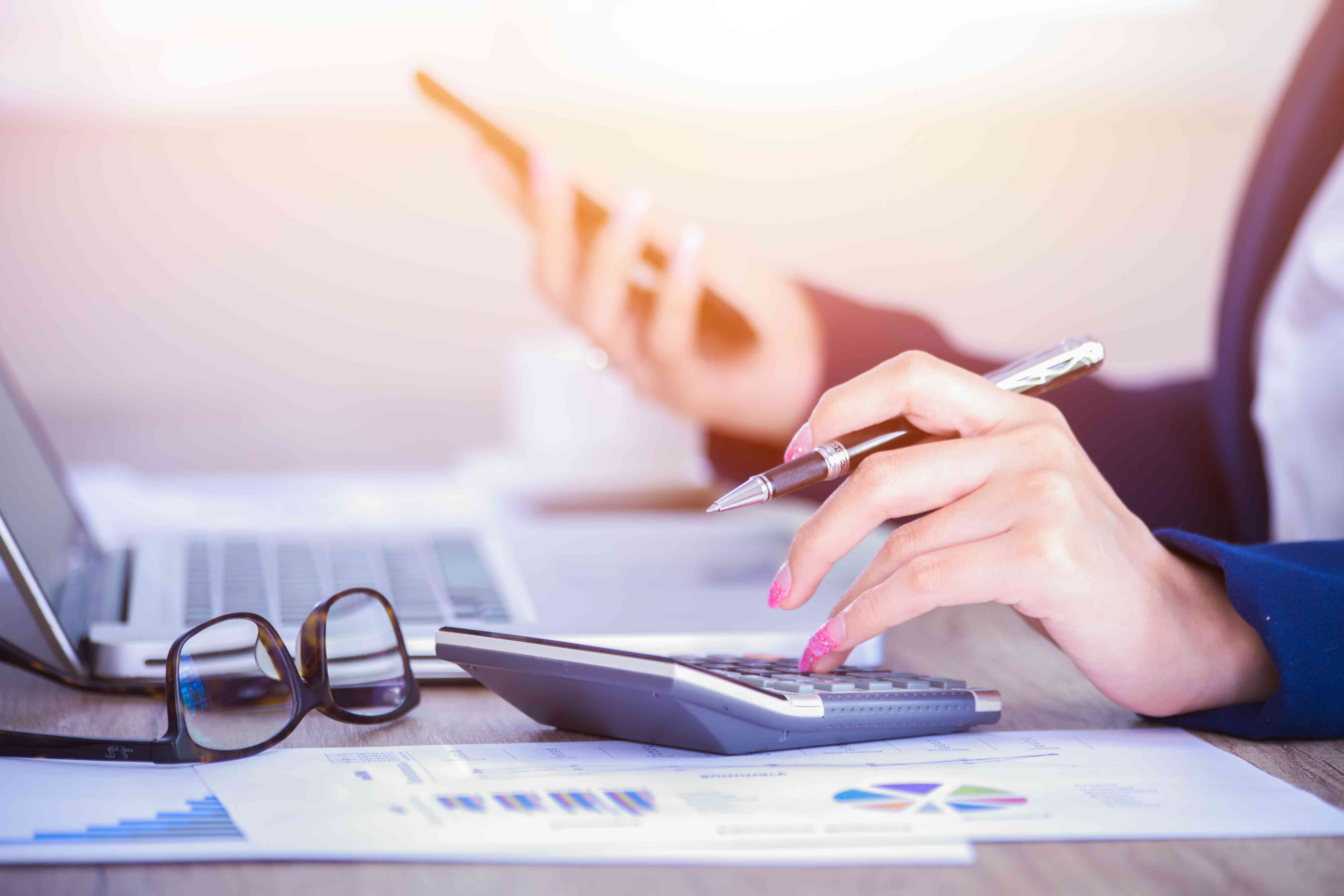 financial advisor at desk with calculator