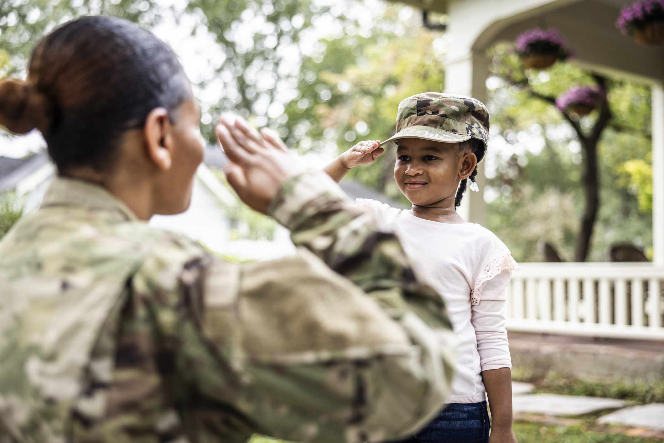 A child salutes a military officer.