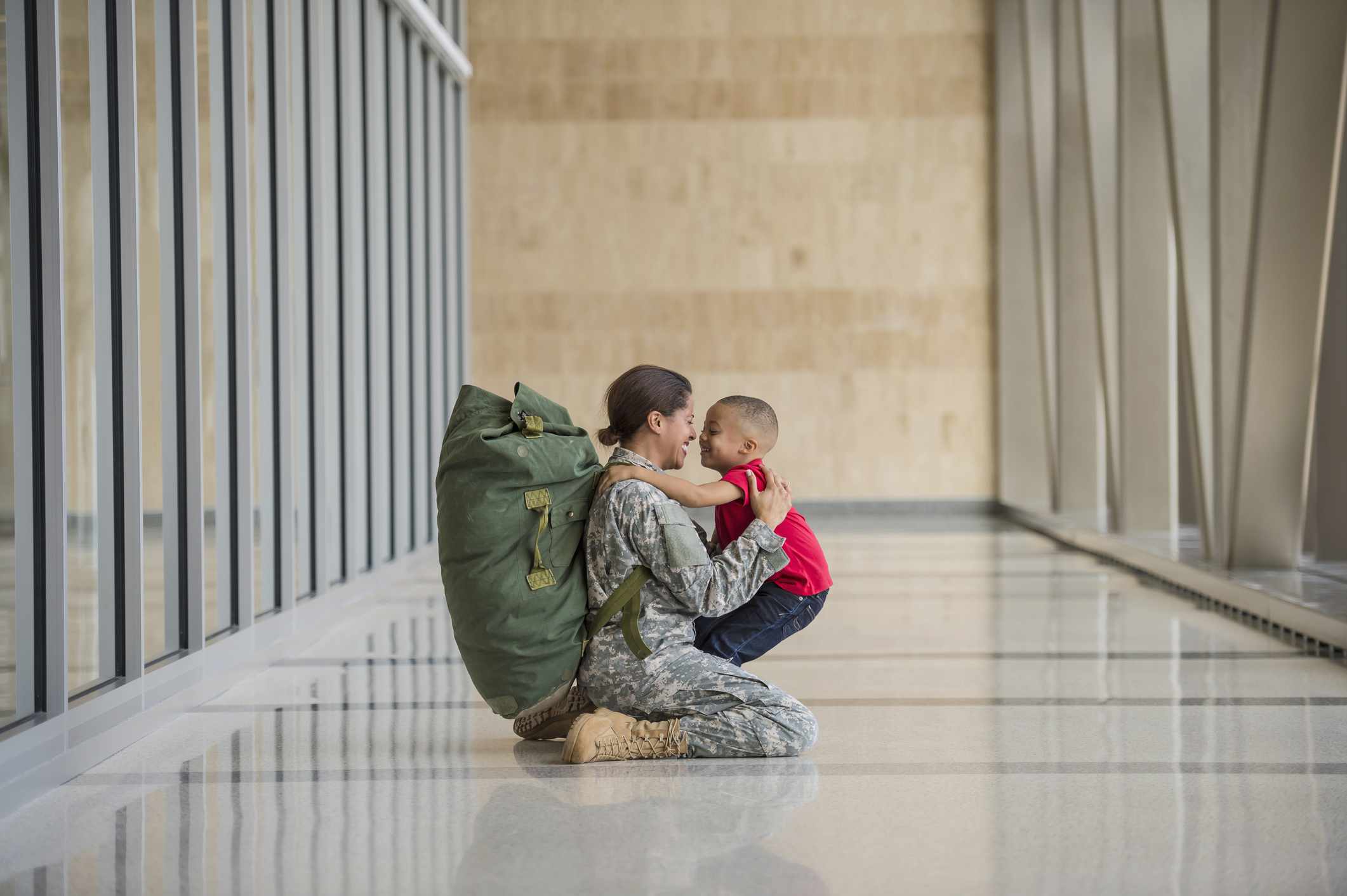 Soldier hugging child at airport