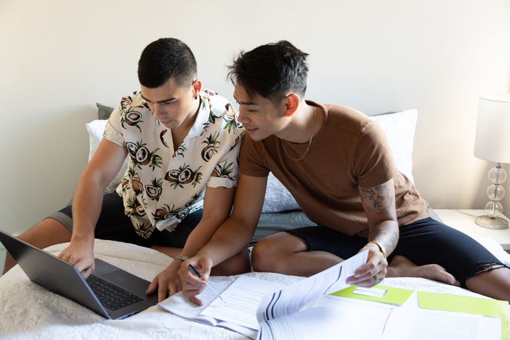 Couple works on taxes in bed