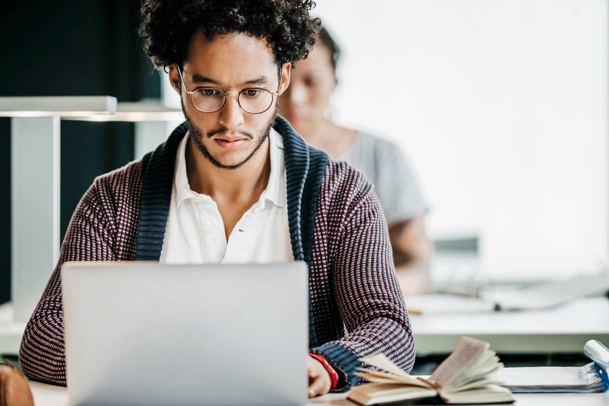 College student concentrates on studies while using a laptop