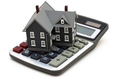 Model of a house sitting on a calculator