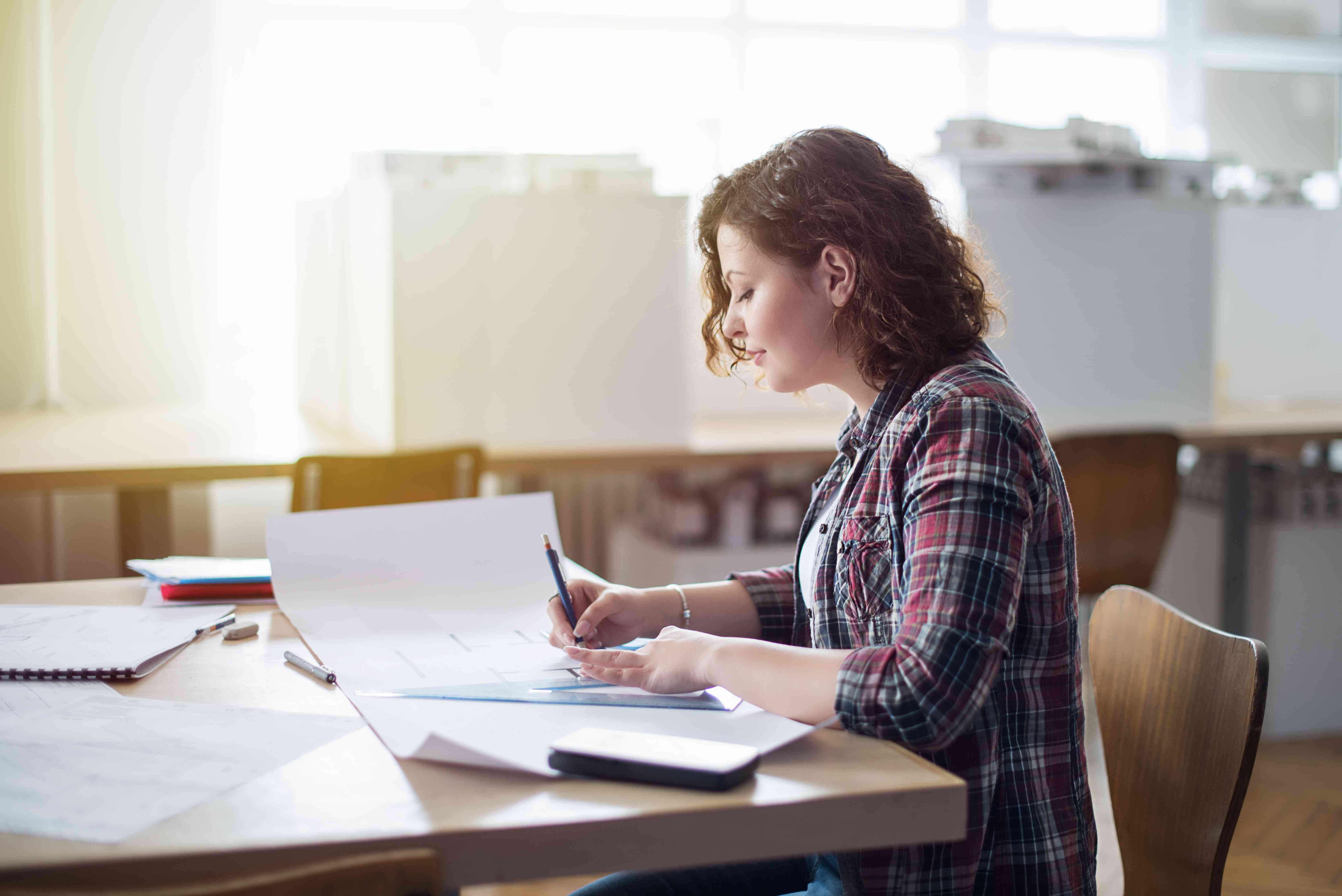 Woman calculating how much it would cost to cancel her student loan debt