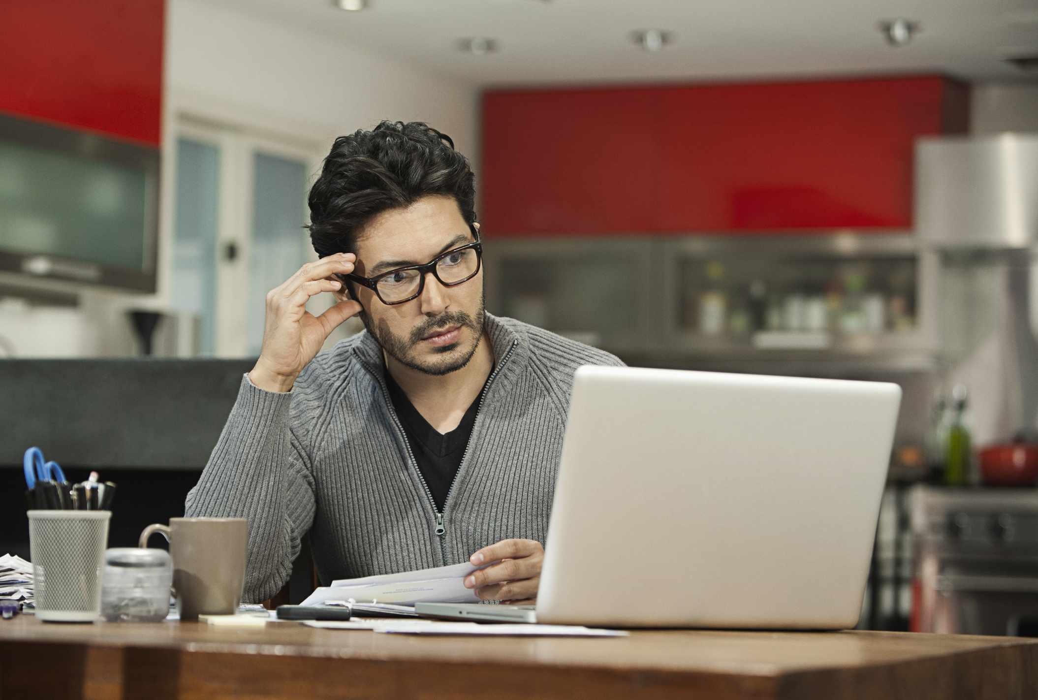 Hispanic man paying bills on computer