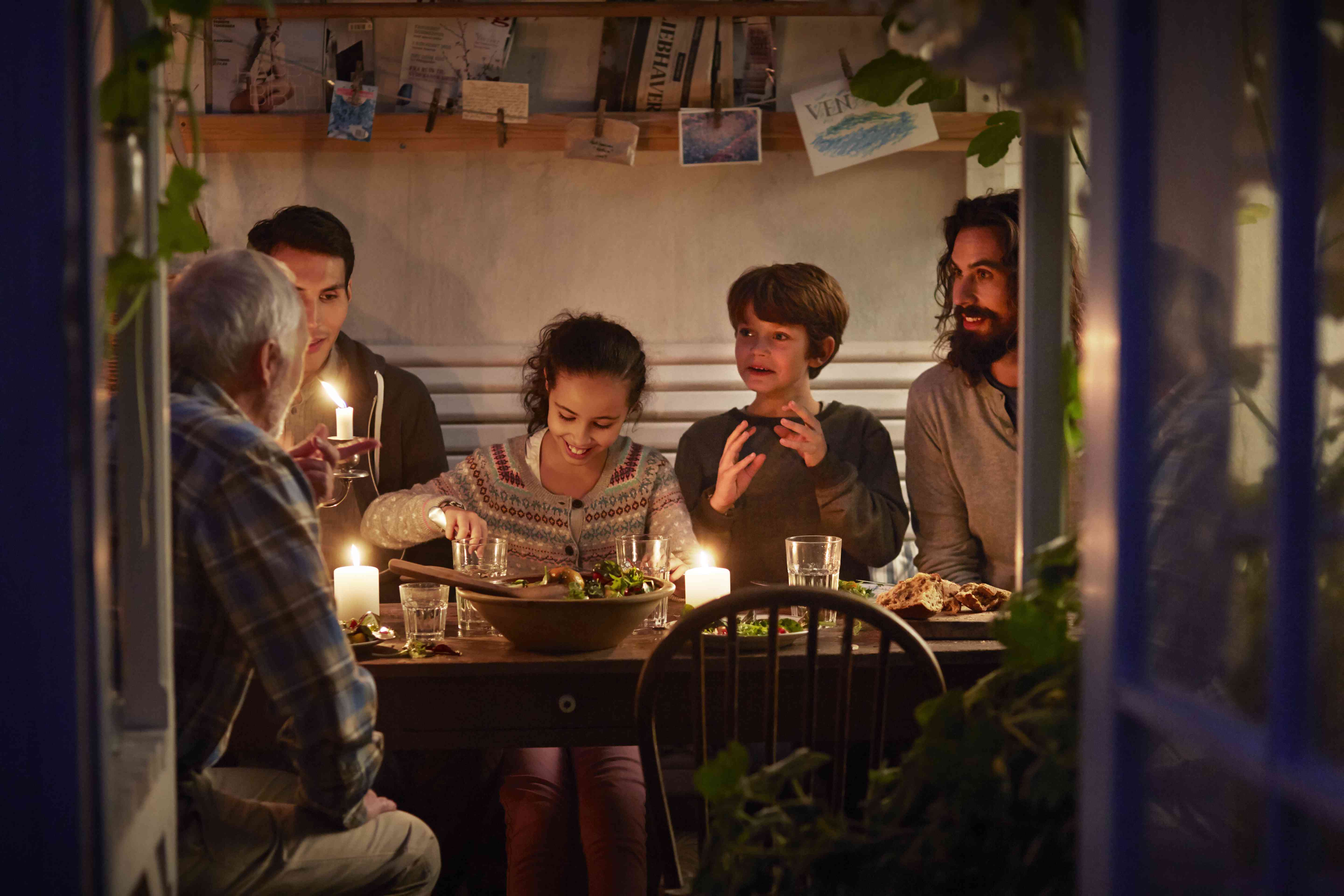 A family eating dinner in a greenhouse