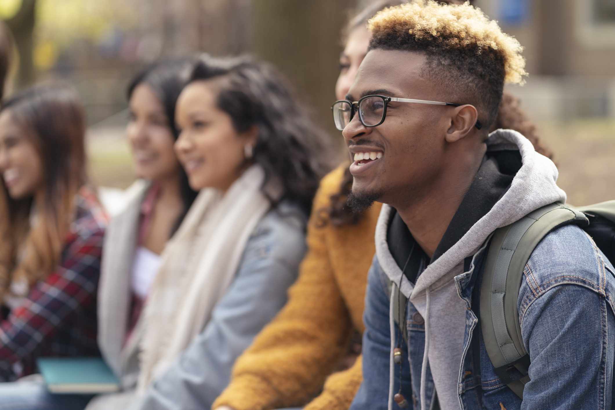 A college student hangs out with friends during a break between classes.