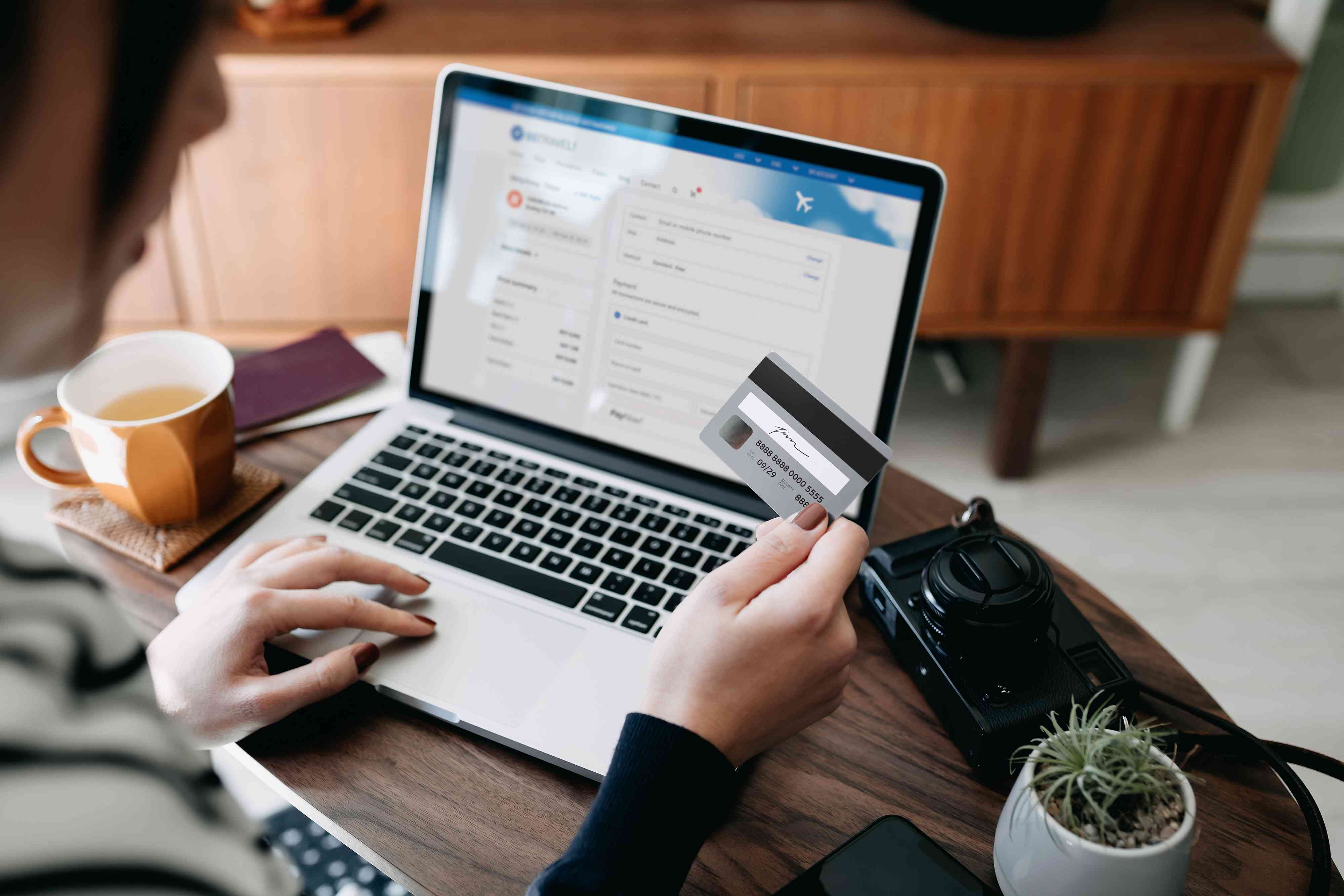 woman shopping online for Bitcoin on website with laptop and credit card