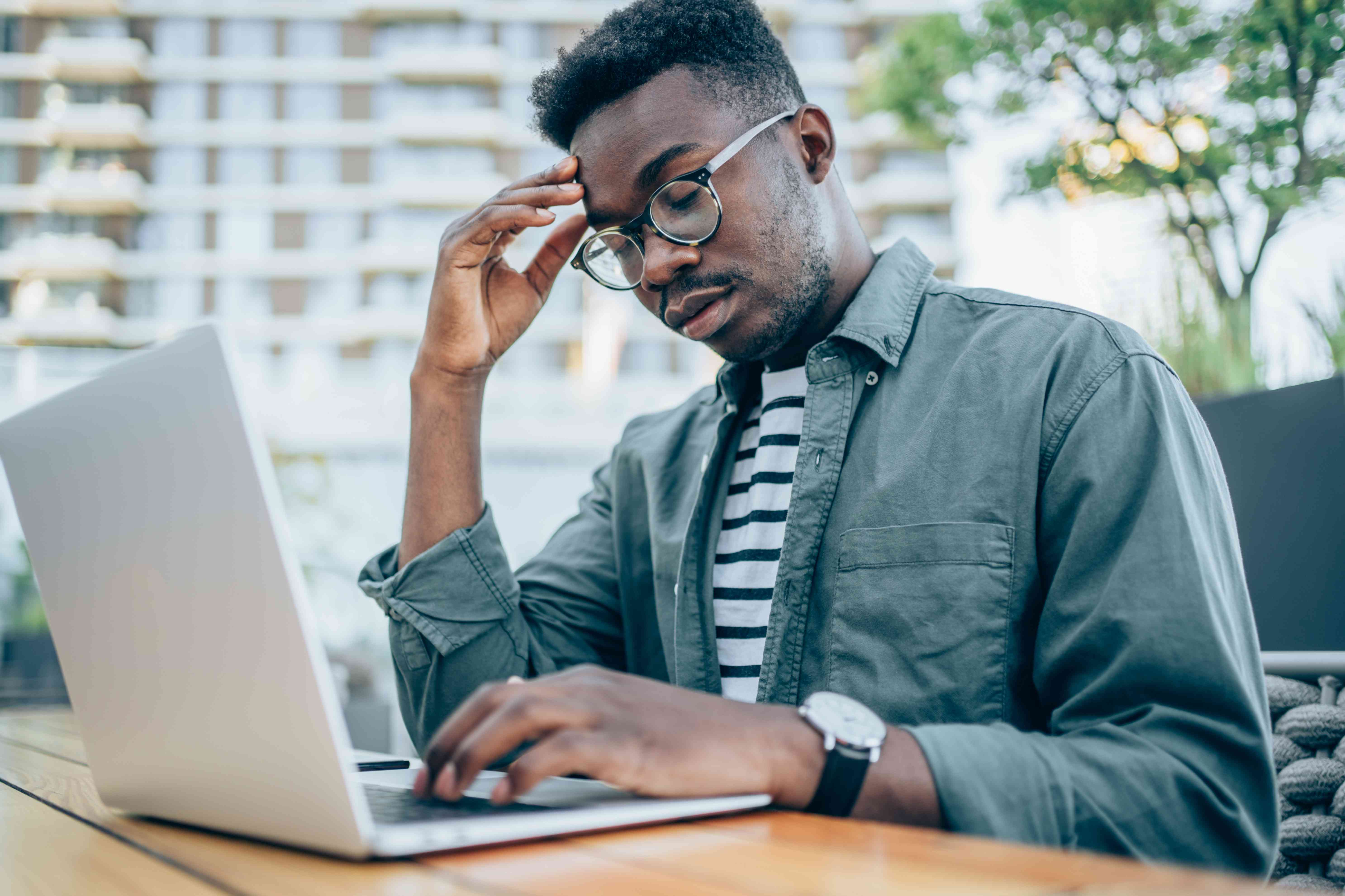 Stressed man at a computer