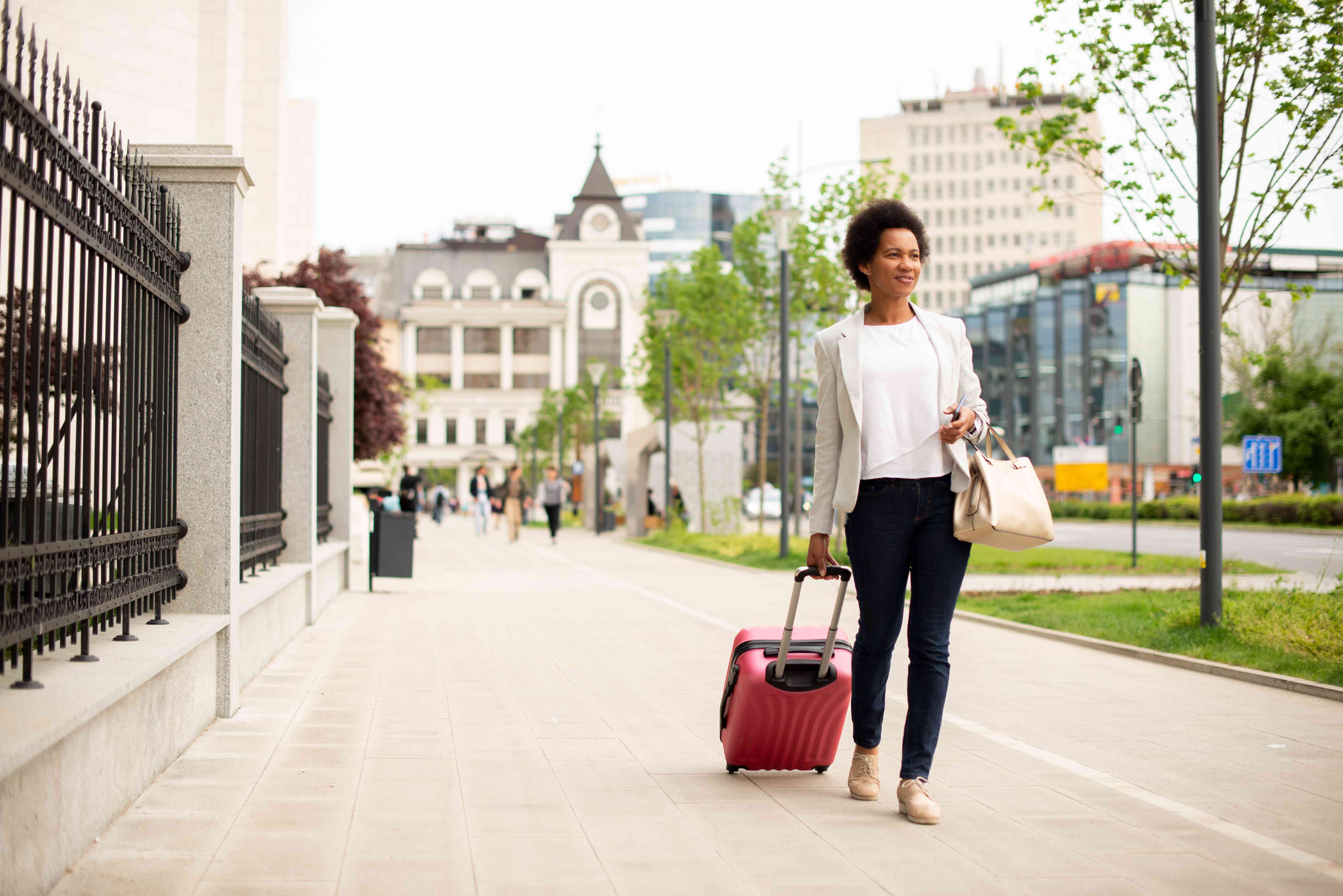 Tourist carries a suitcase.