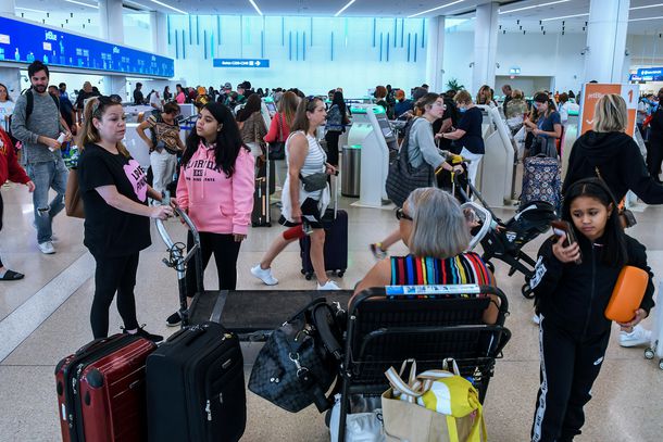 Travelers make their way through Orlando International Airport during the busy 2023 Labor Day holiday weekend