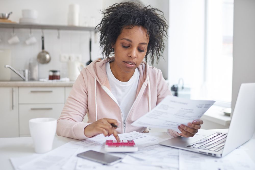 Woman reviewing finances for student loan deferment