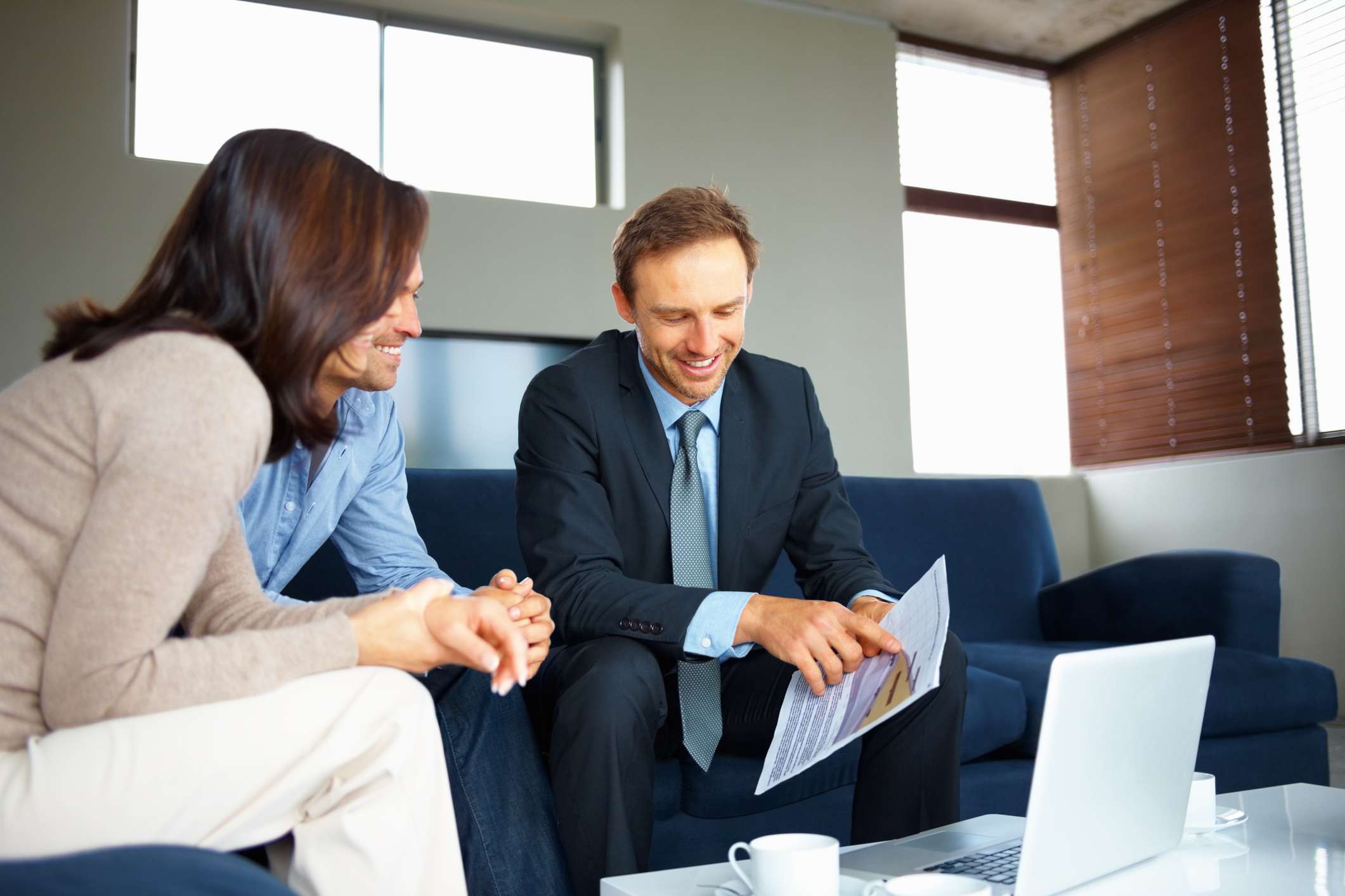 A man going over paperwork with a couple